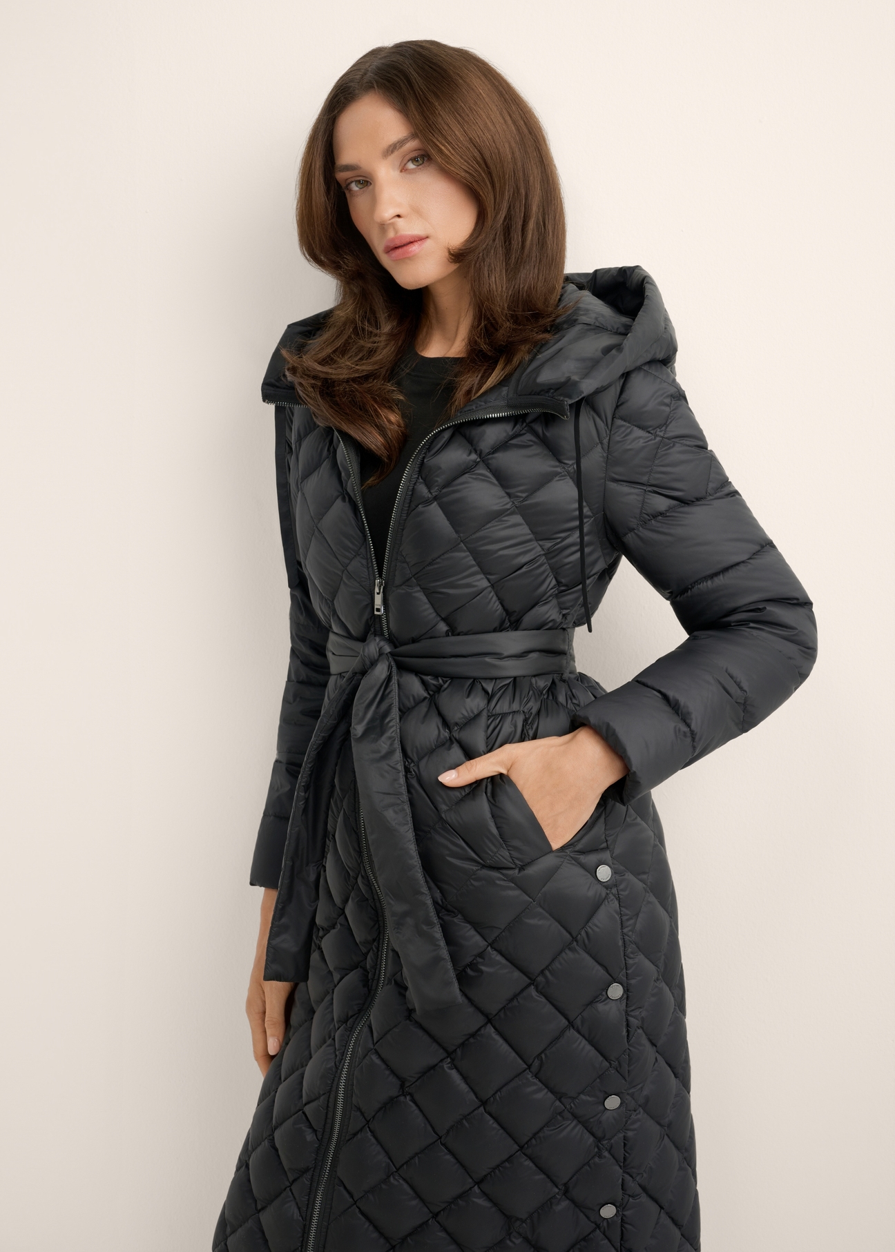 Black women's jacket with natural insulation KURDT-0691-99(Z26), front view of the product on a model. Half of the silhouette visible.