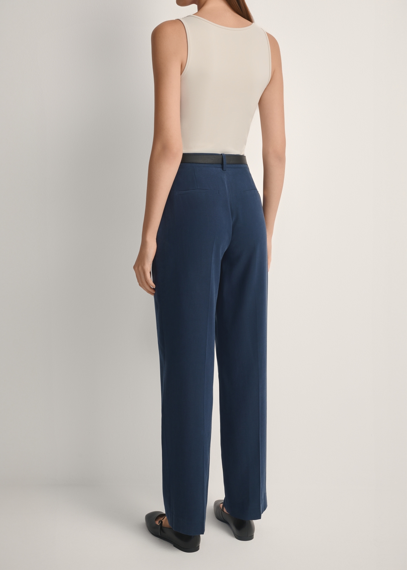 Navy blue elegant women's trousers SPODT-0106A-7E(W26), product view from the back on the model, half of the silhouette visible.