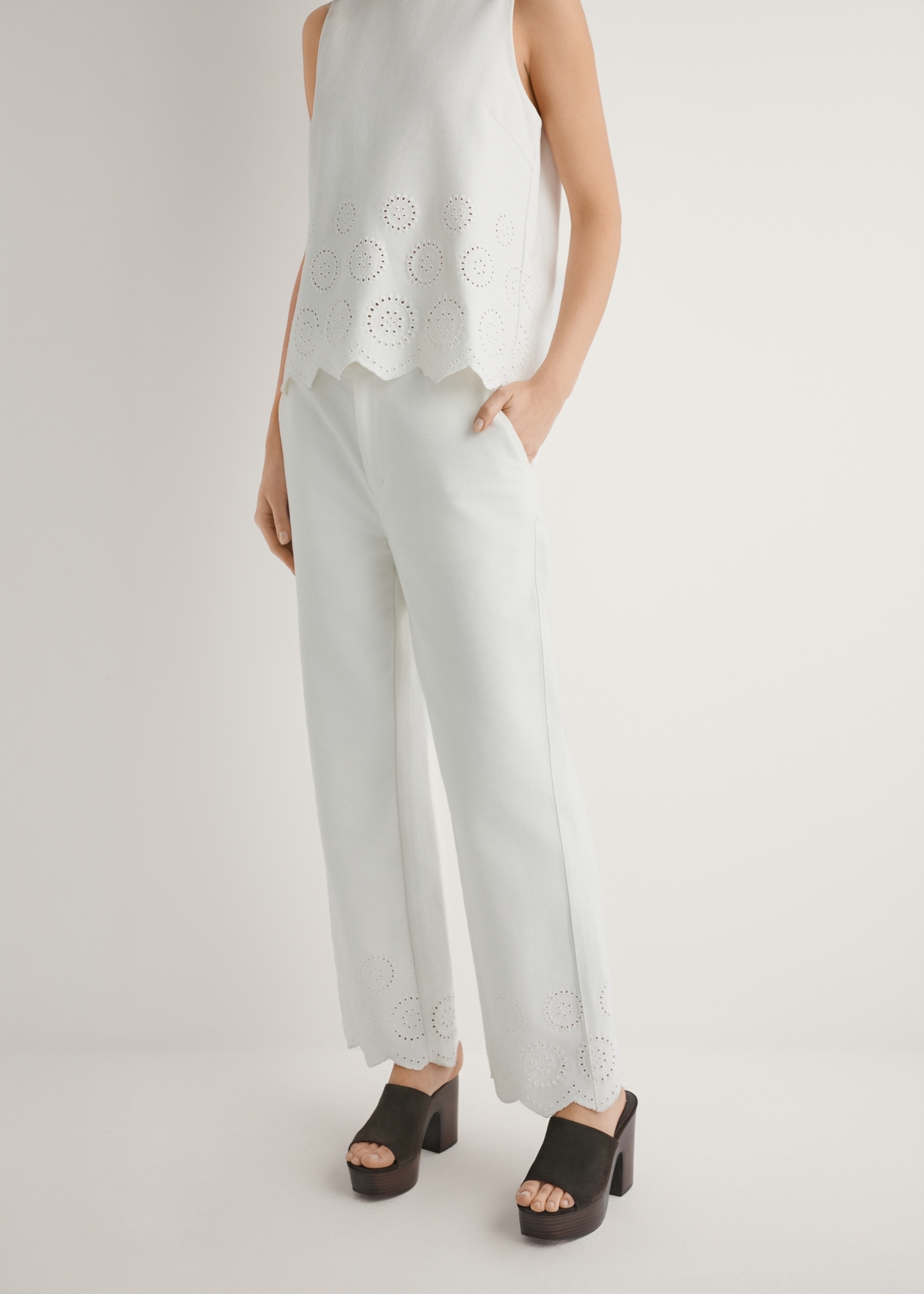 Women's white wide leg trousers SPODT-0122-0B(W26), front view of the product on the model. Half of the silhouette visible.