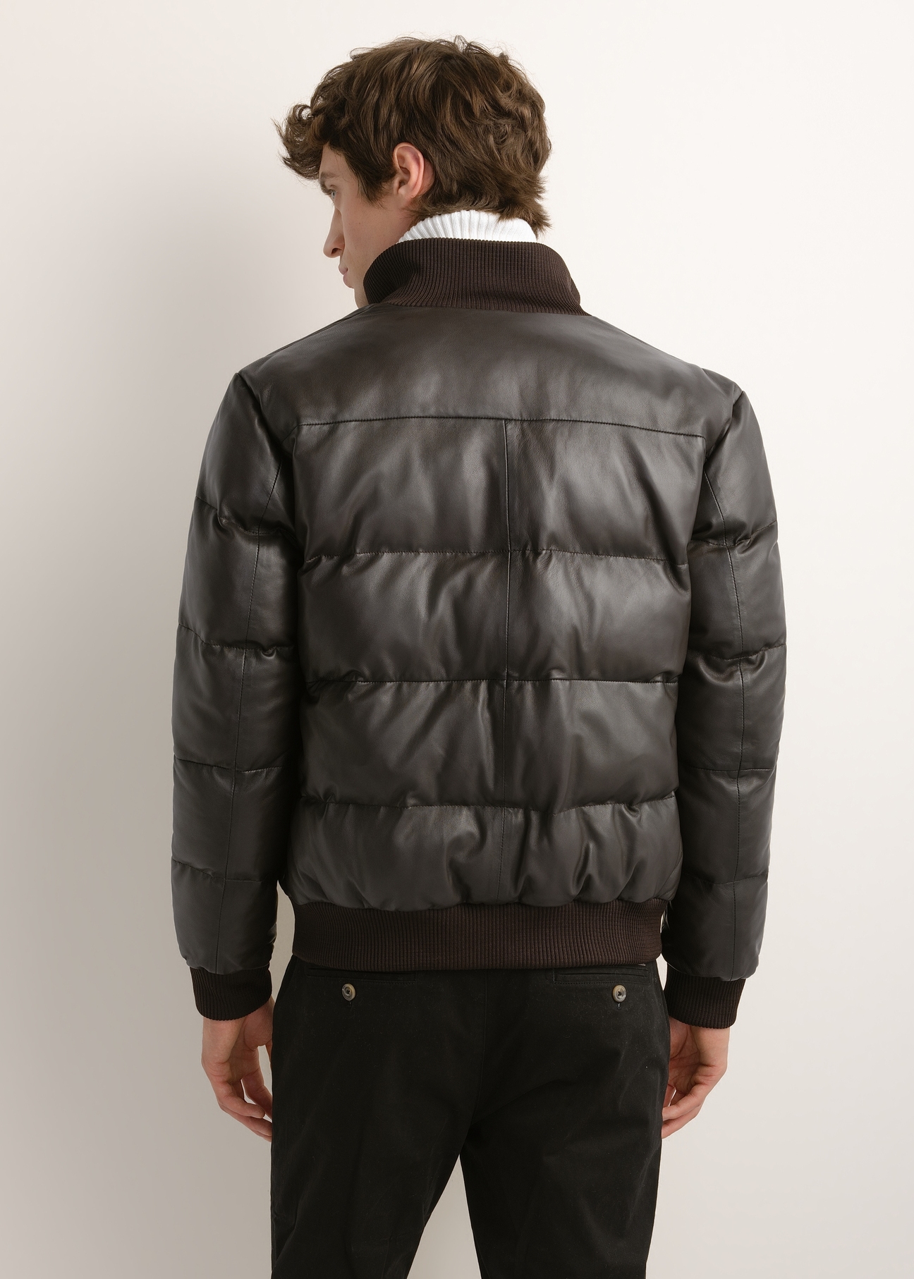 Men's dark brown leather jacket with a stand-up collar (model KURMS-0428-1I(Z26)); rear view on a model, showing half of the figure.