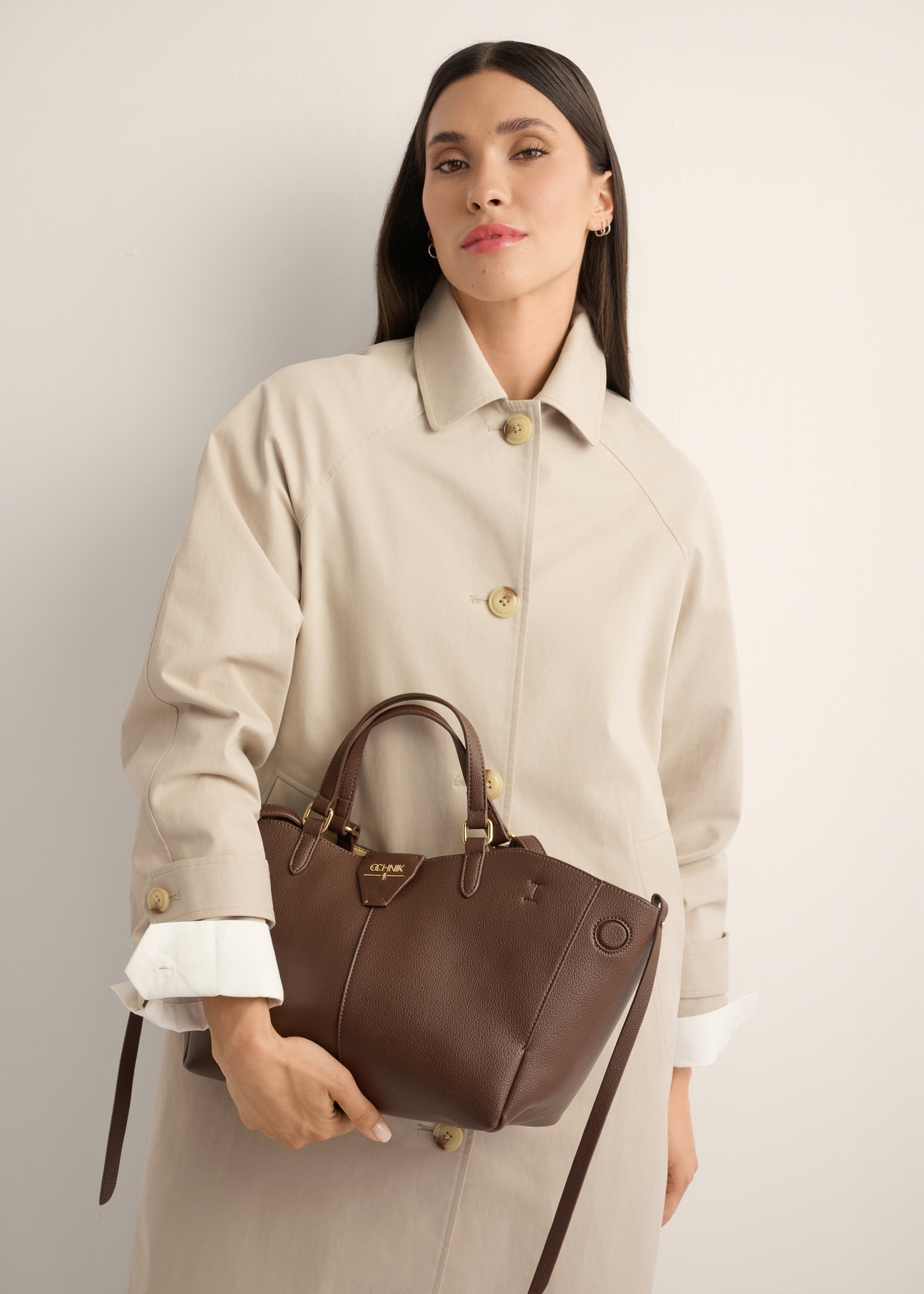 Brown women's shoulder bag TOREC-1231-1H(Z26), front view of the product on a model, half of the silhouette visible.