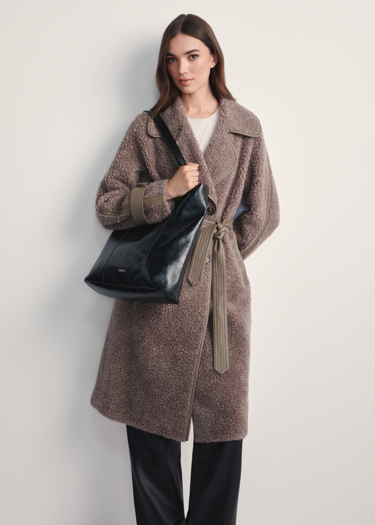 Black women's shopper bag TOREC-1086-99(Z25) - front view of the product on a model against a white background. Full body visible.