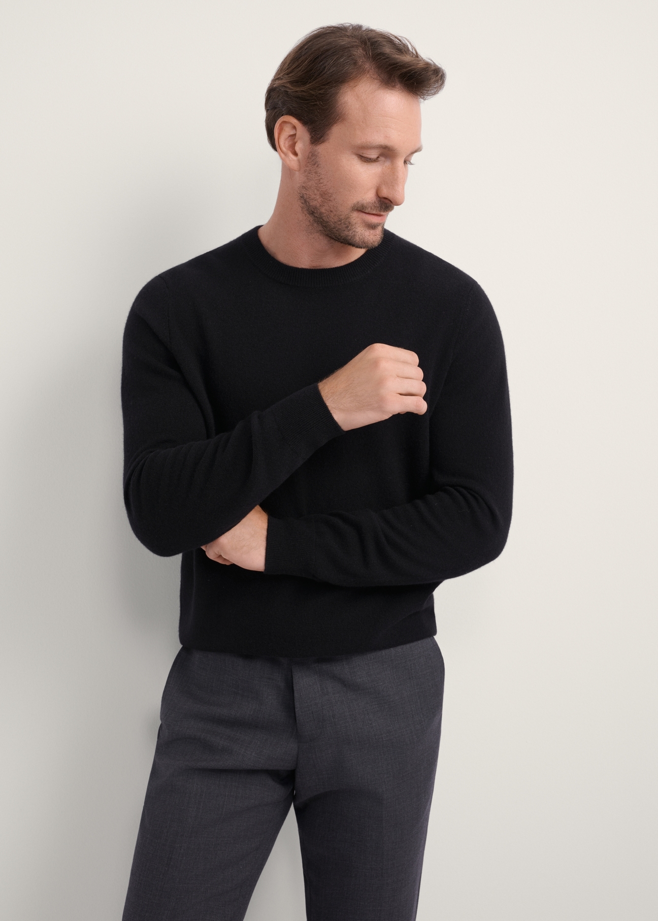 Black men's wool cashmere sweater SWEMT-0186-99(Z25), front product view on model. Half silhouette visible.