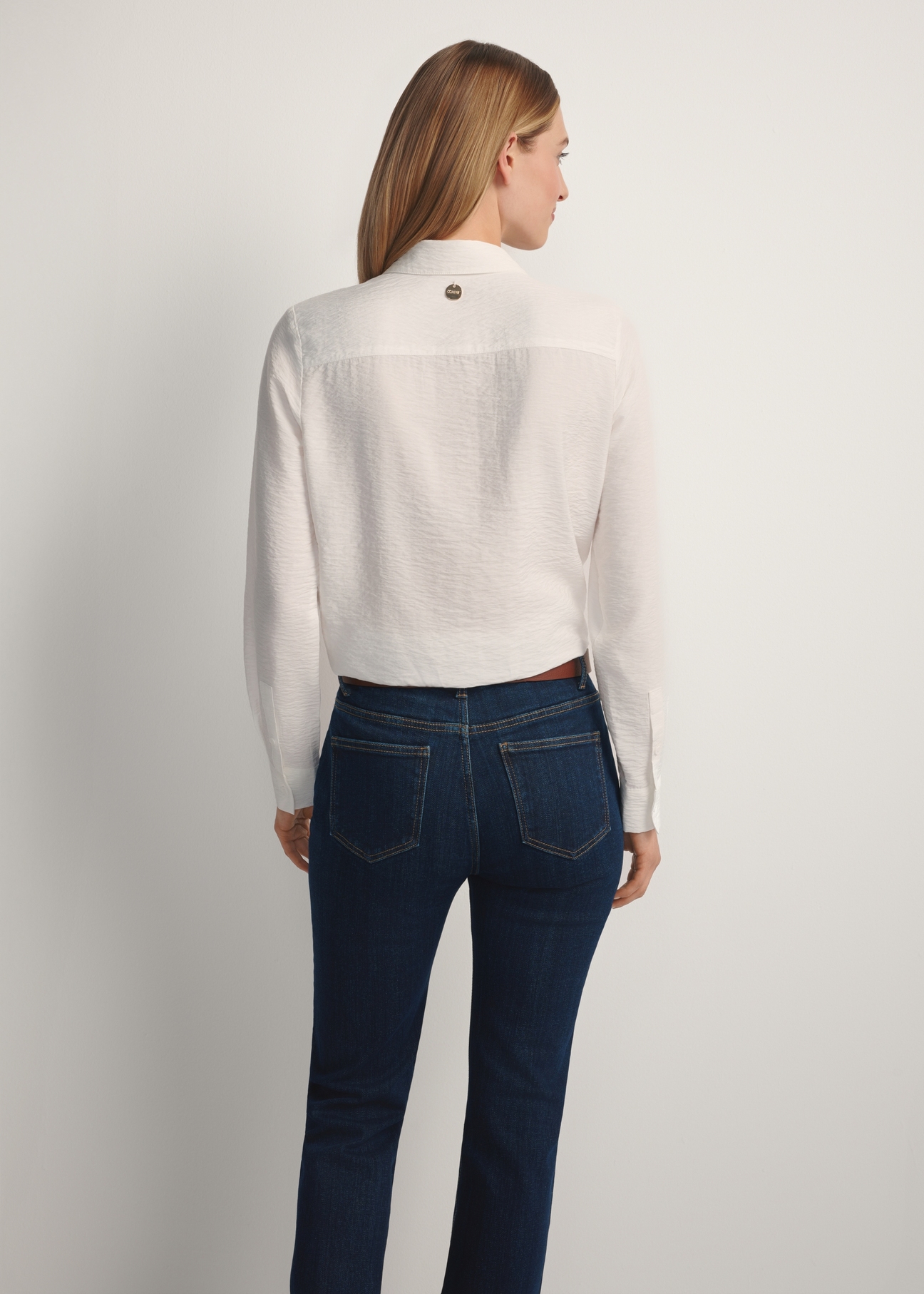 White women's shirt KOSDT-0180-0P(W26), back view of the product on the model. Half of the silhouette visible.