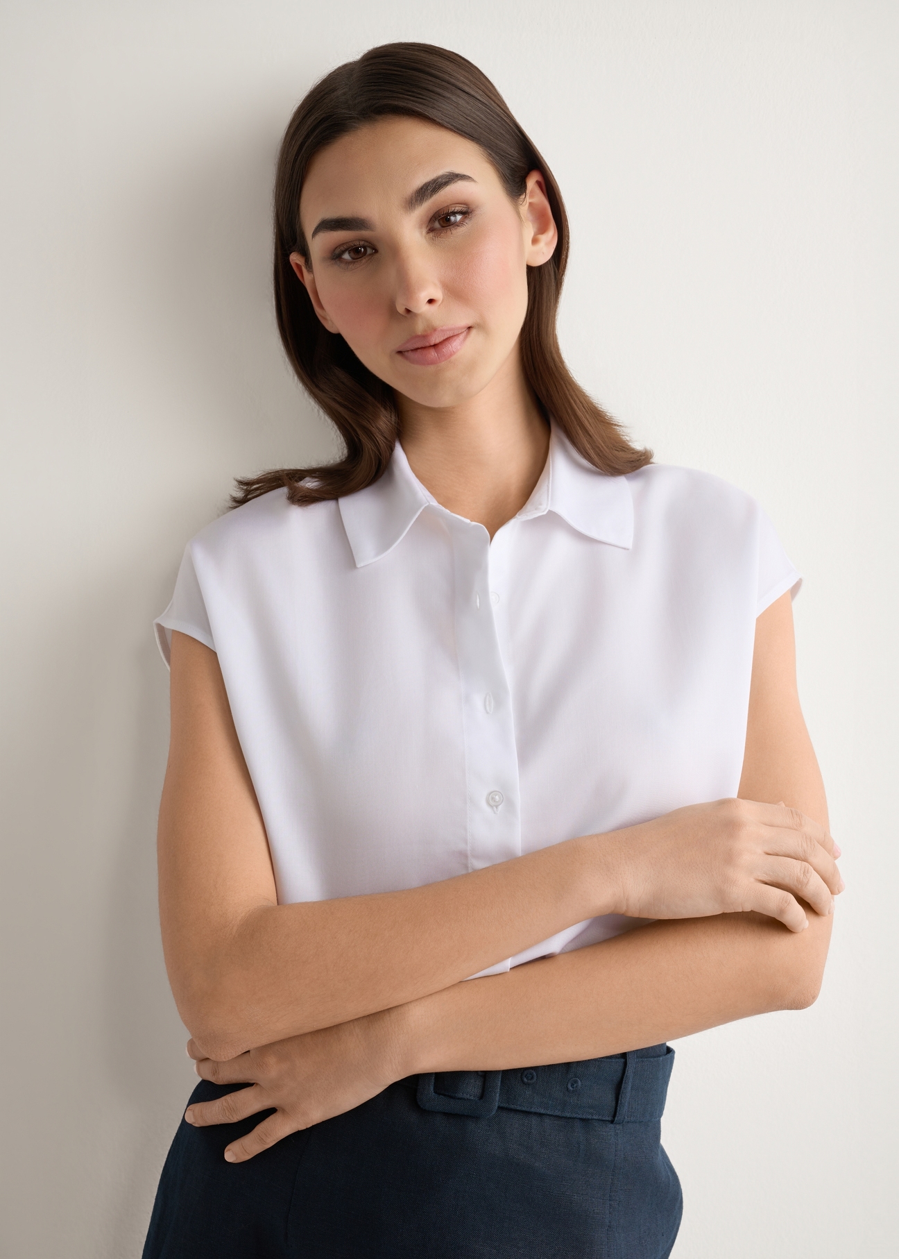 White women's shirt KOSDT-0189-0A(W26), front view of the product on the model. Half of the silhouette visible.