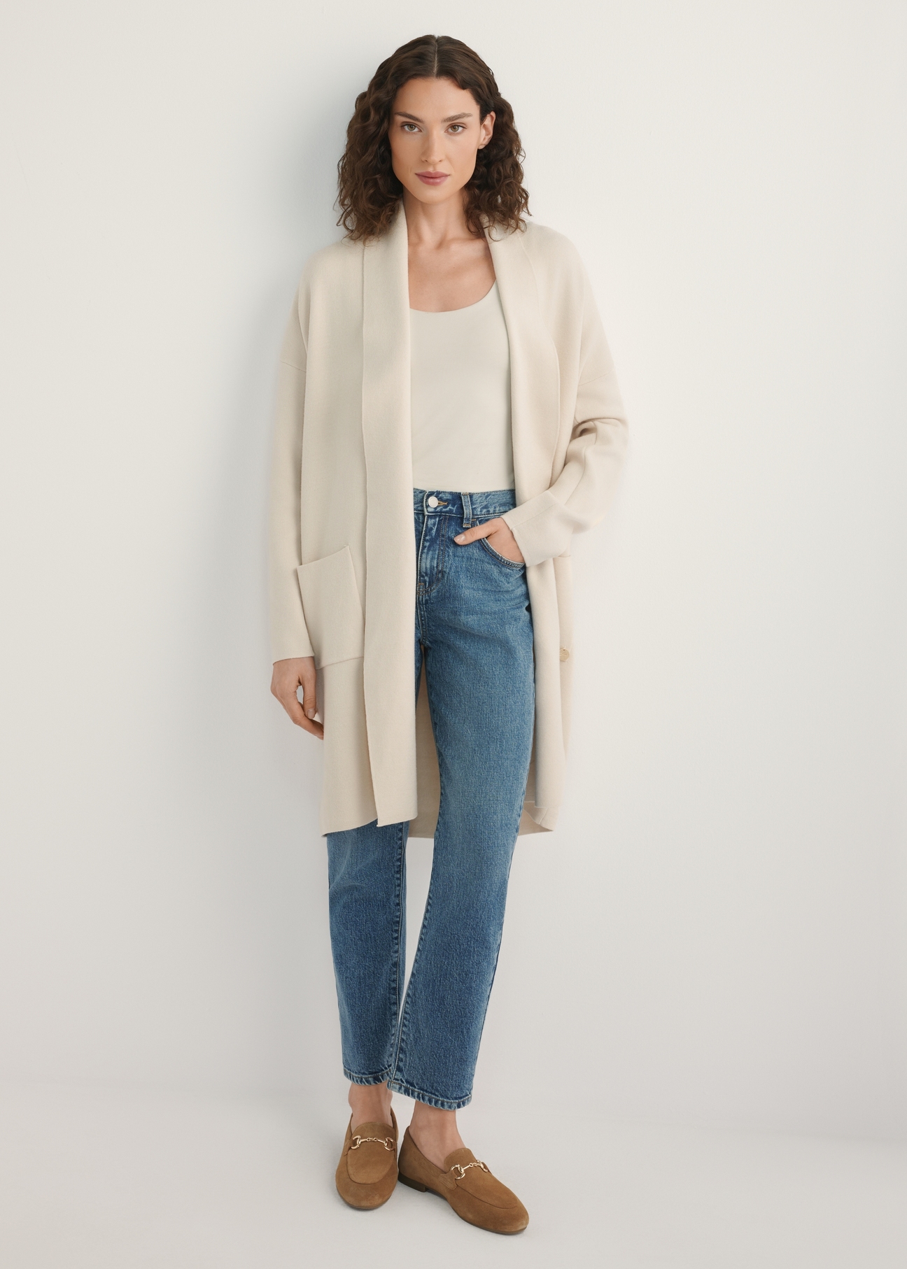 Beige women's cardigan KARDT-0041-1A(W26), front view of the product on the model. Half of the silhouette visible.