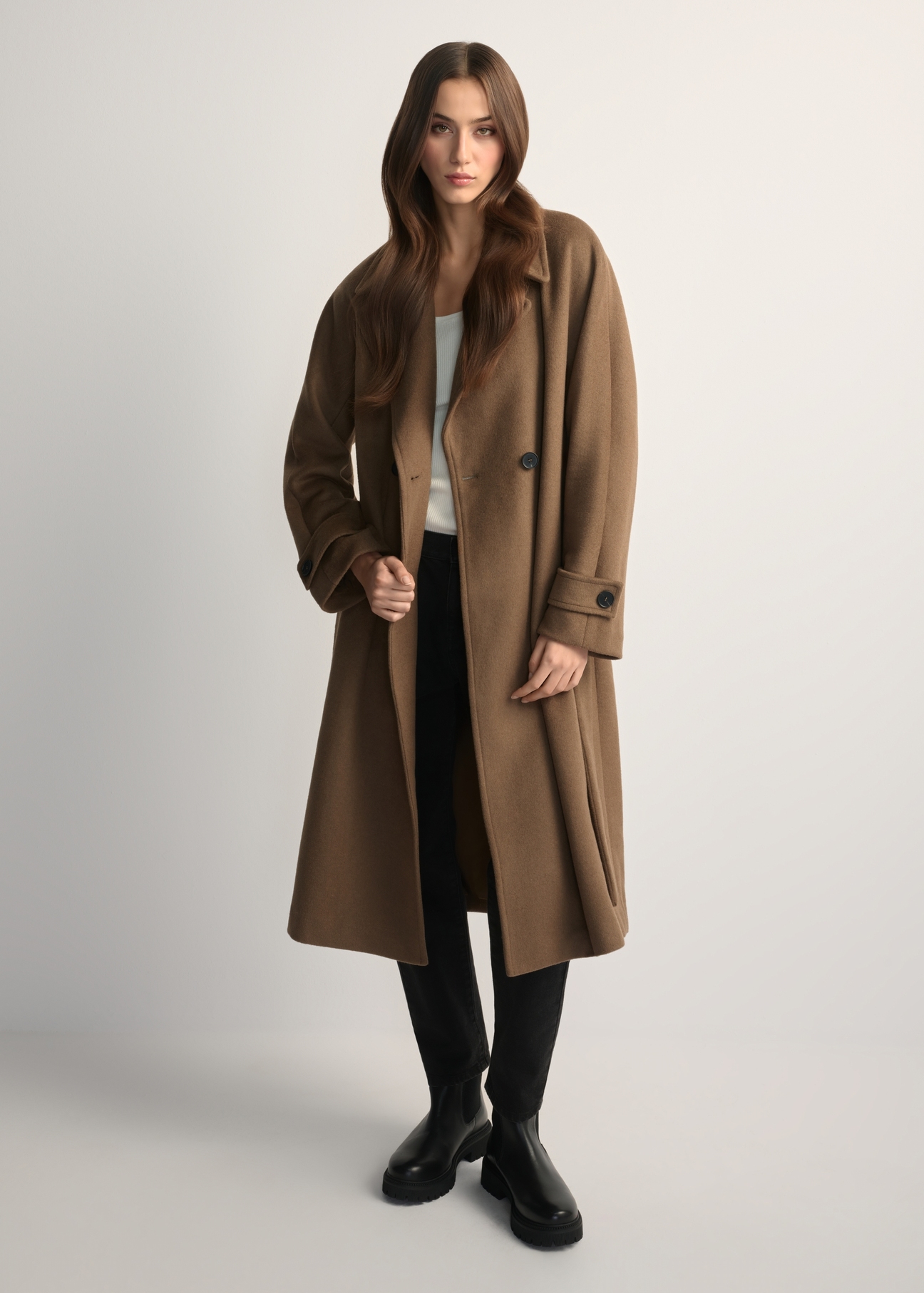 Women's woolen camel coat PLADT-0061-24(Z25) - front view of the product, on a model, on a light background. The entire silhouette is visible.