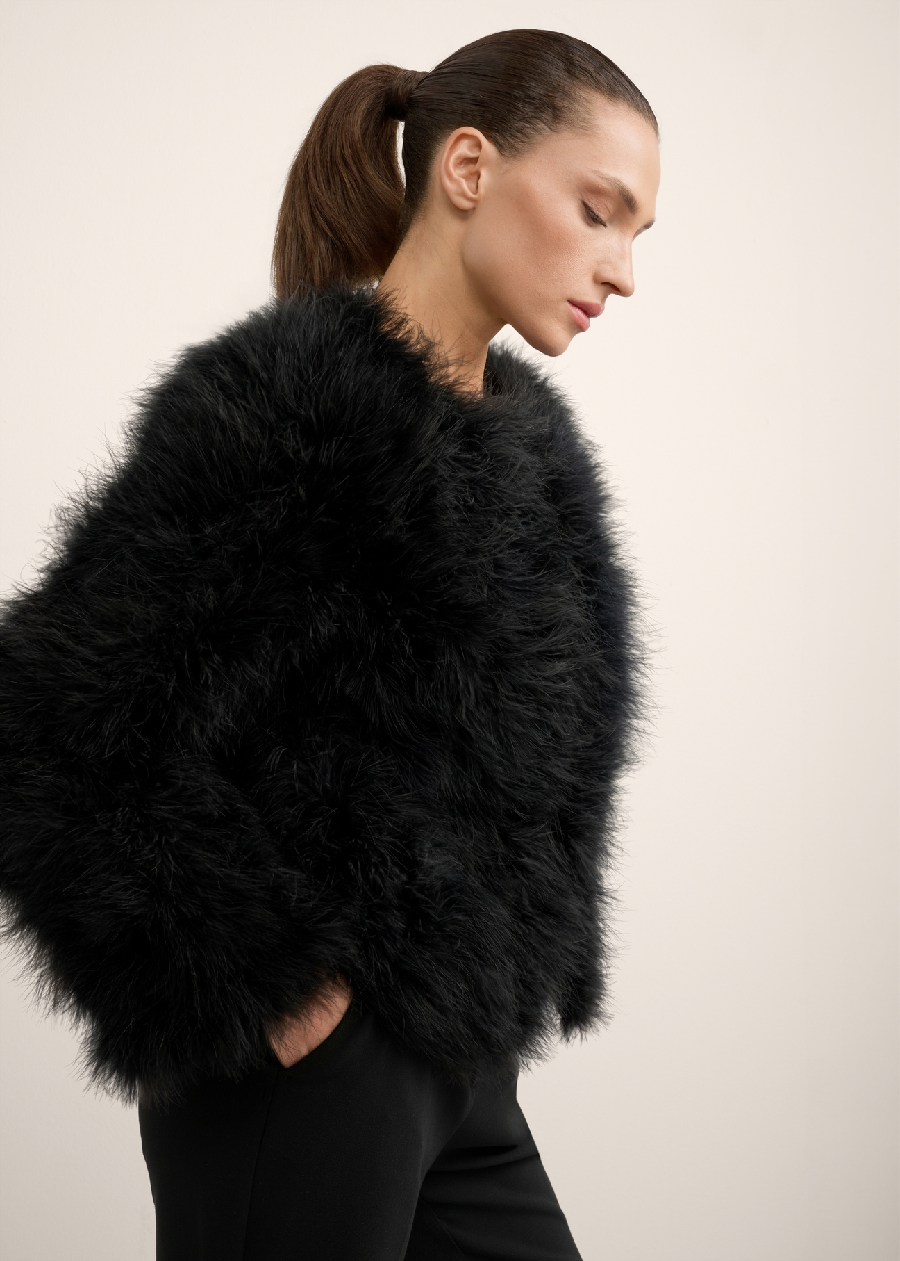 Women's black turkey feather fur coat FUTDF-0097A-99(Z26), side view of the product on the model. Half of the silhouette visible.