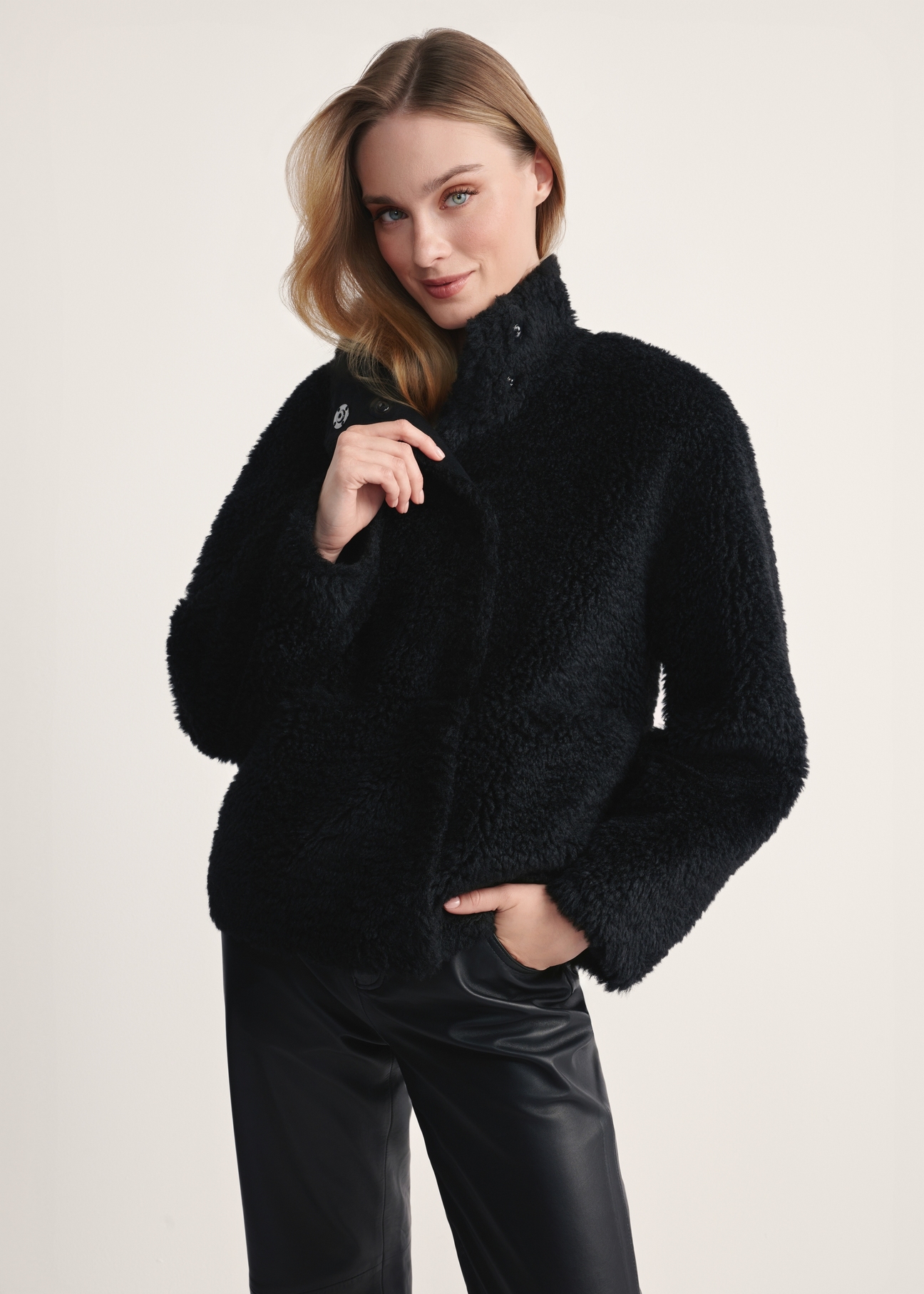 Women's black fur coat FUTDP-0021B-99(Z25), front view of the product on the model. Half of the silhouette visible.