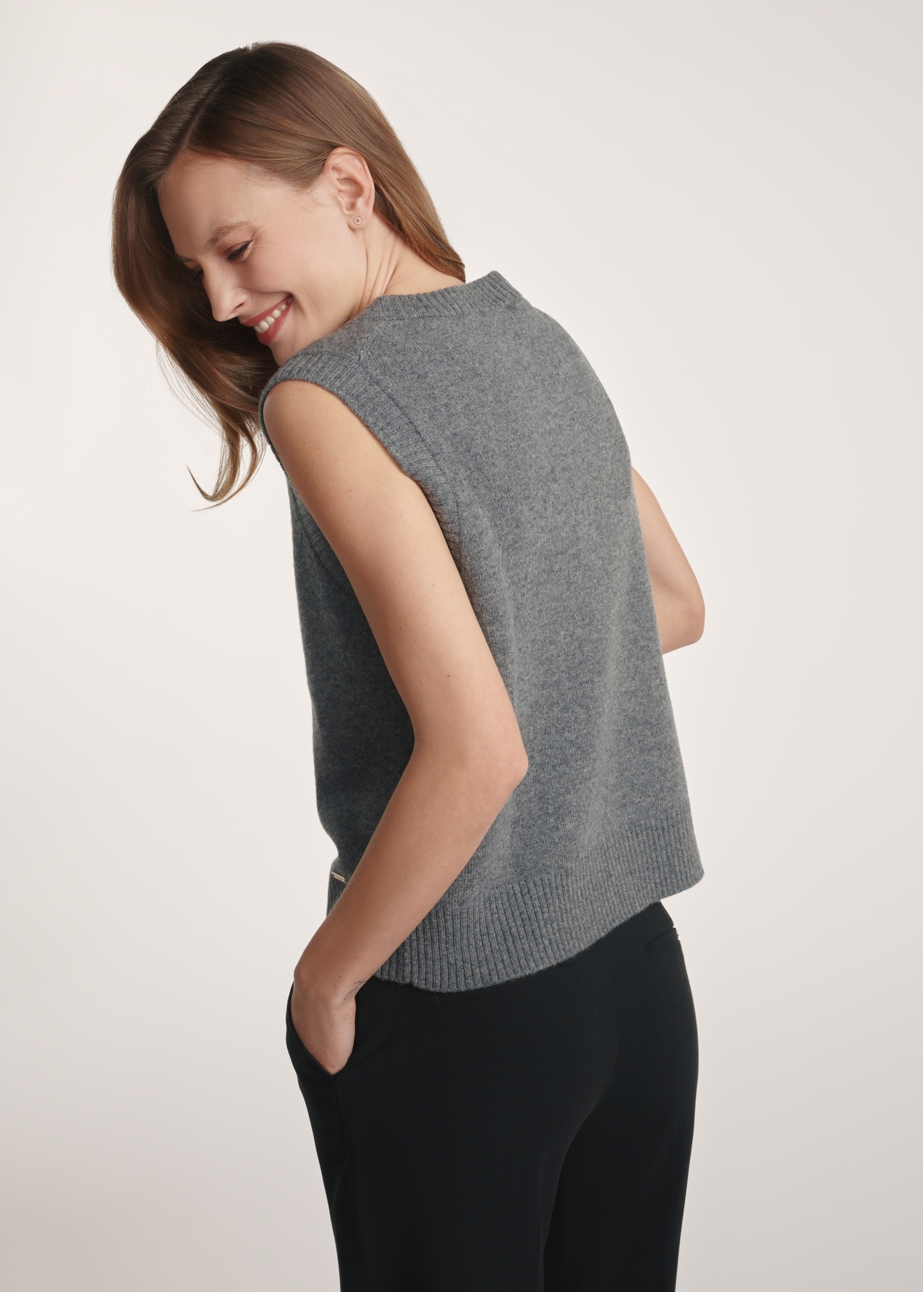 Women's woolen vest in gray color SWEDT-0253-91(Z25), product visible from the back on the model, half of the silhouette visible.