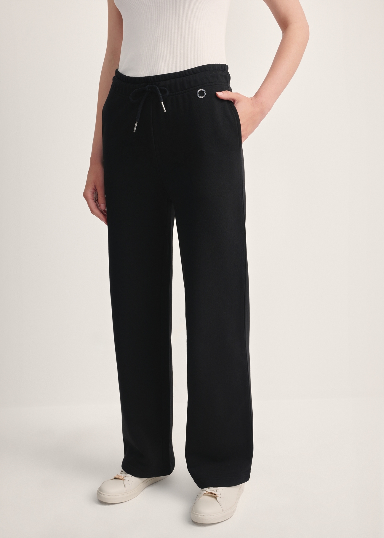 Black women's trousers SPODT-0111-99(Z25), front view of the product on the model. Half of the silhouette visible.