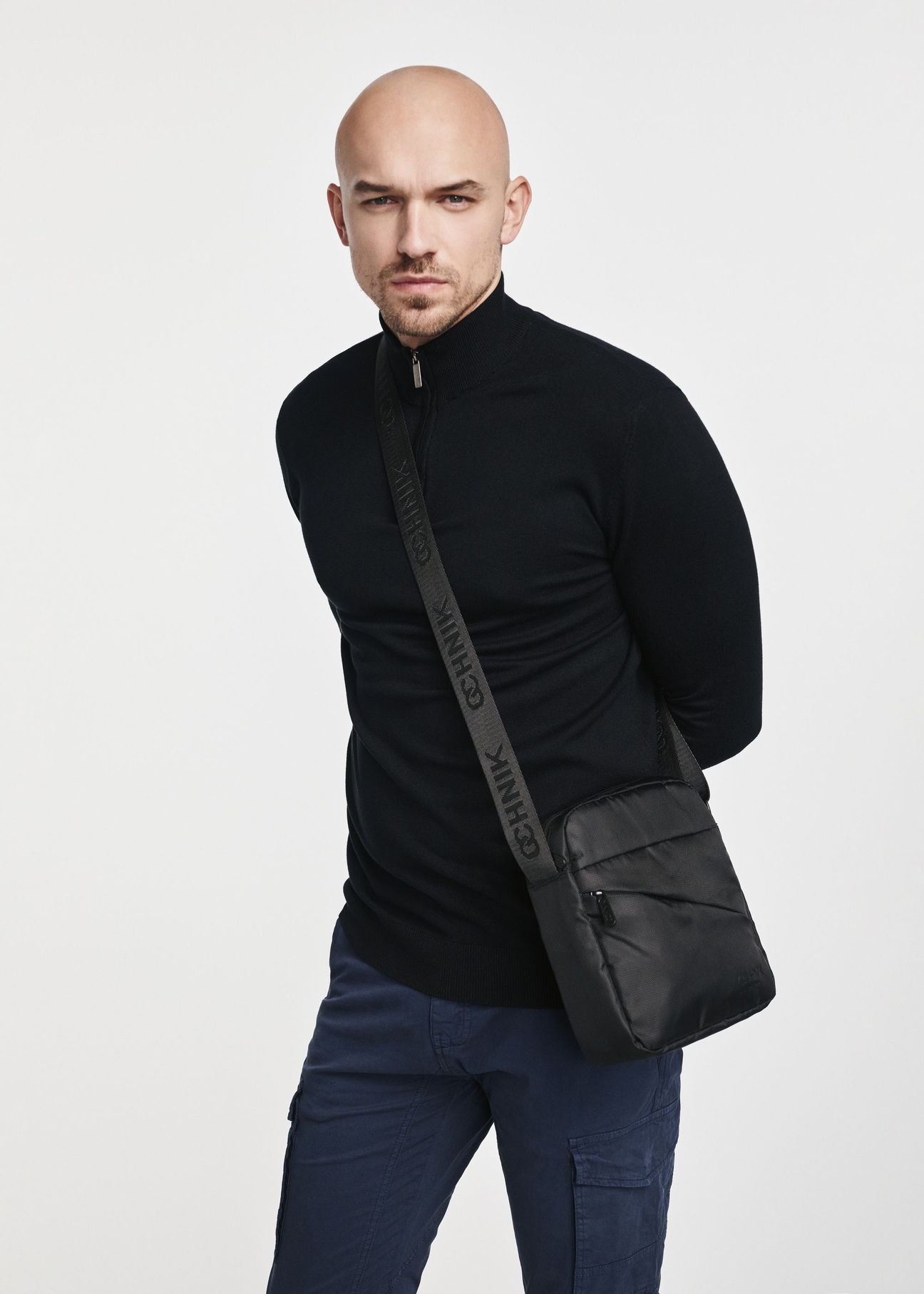 Black men's bag TORMN-0266C-99(Z25), product view on model. Half silhouette visible.