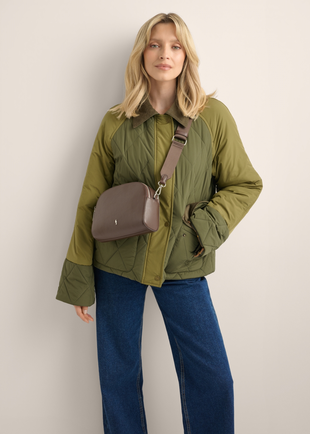 Small brown two-compartment leather women's handbag TORES-1349-1H(Z26), diagonal view of the product on the model. Half of the silhouette visible.