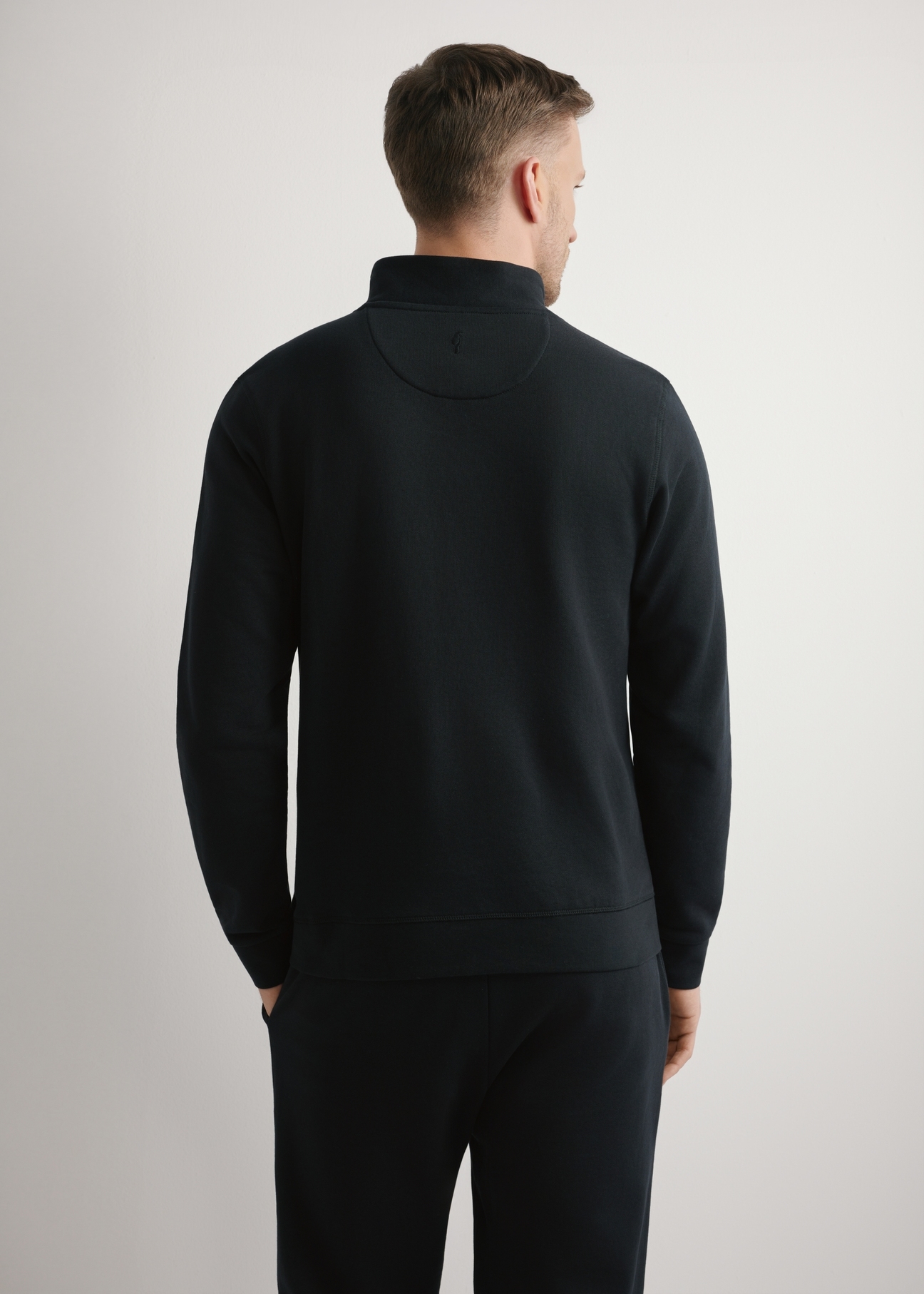 Black men's sweatshirt with stand-up collar BLZMT-0080-99(W26) - product view from the back, on a model, on a light background.