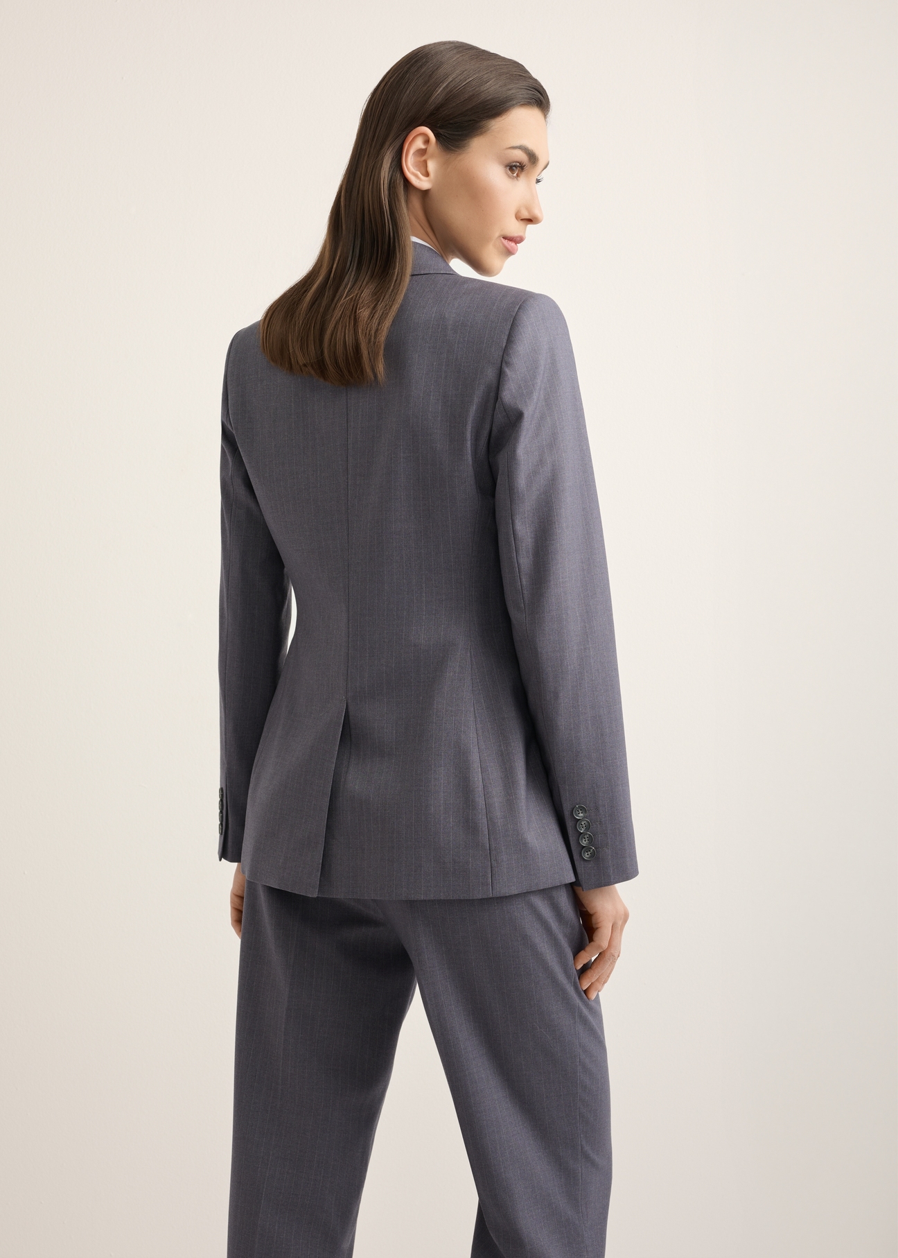 Women's gray blazer ZAKDT-0050-9D(Z26), back view of the product on the model. Half of the silhouette visible.