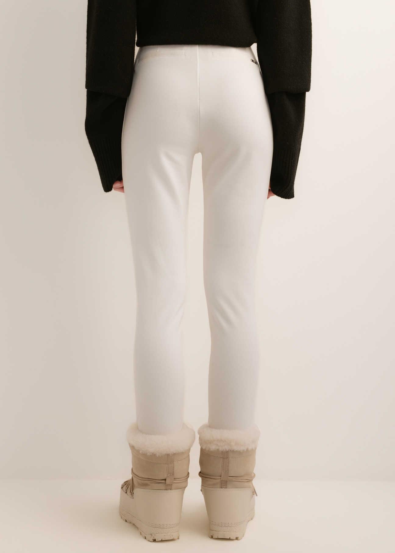Cream-colored, fitted women's trousers SPODT-0096-0B(Z26); rear view of the product on a model. Half-body shot.