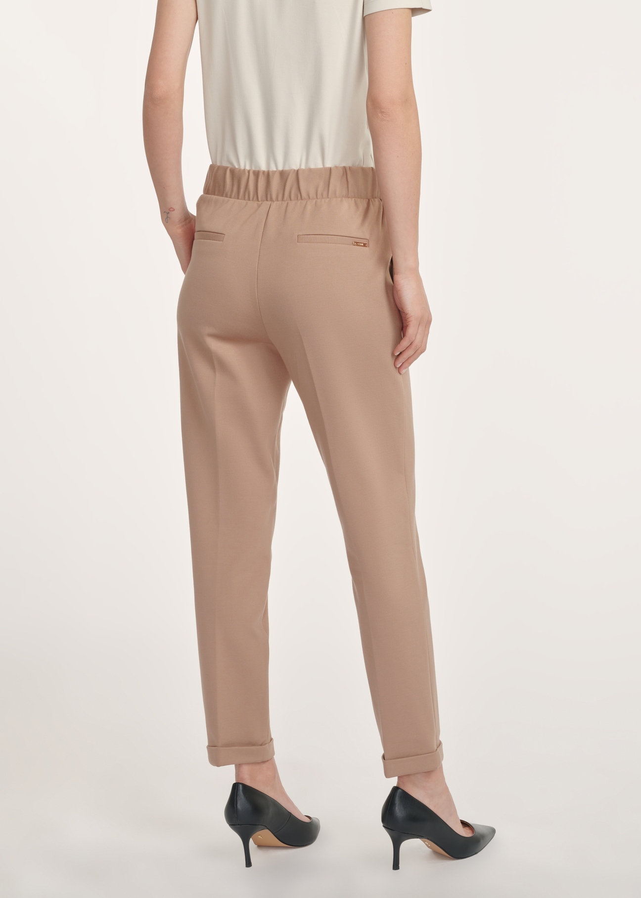 Women's camel trousers with a crease SPODT-0098-24(Z24), product view from the back on the model, half of the silhouette visible.