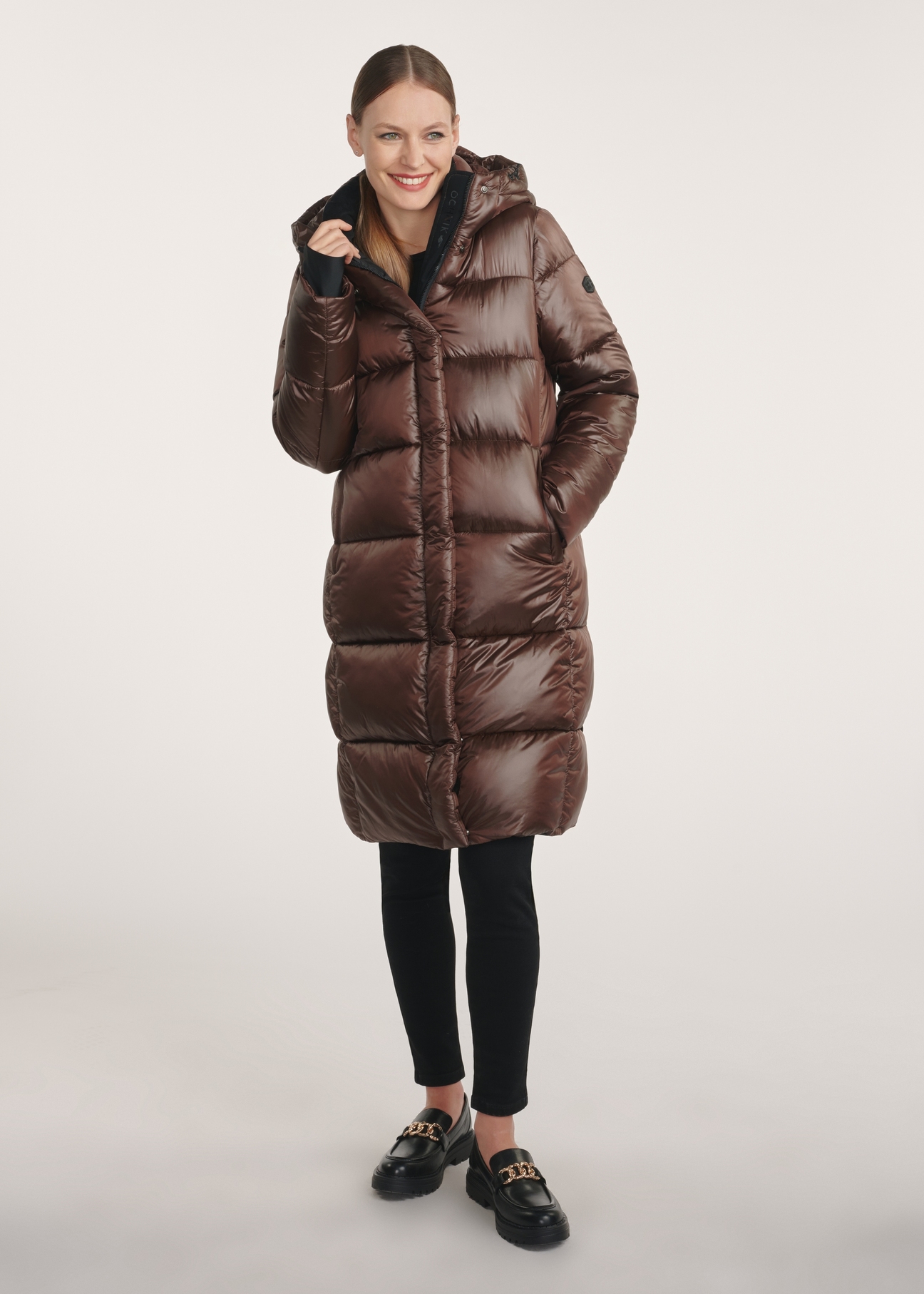 Brown long winter women's jacket KURDT-0531-89(Z25) - front product view on a model on a white background. The entire silhouette is visible.