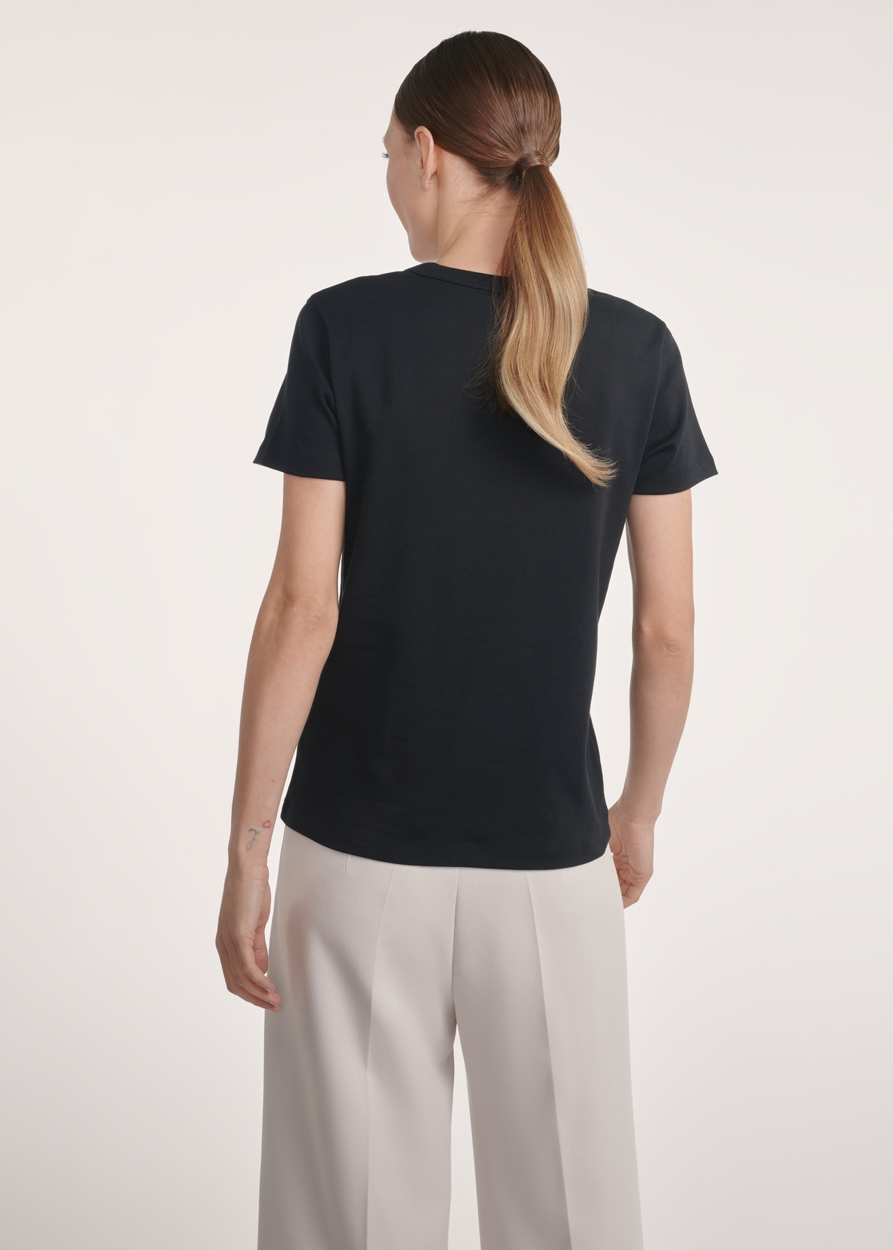 Black cotton women's t-shirt TSHDT-0144-99(Z25) - back view on a model on a white background. Half of the silhouette visible.
