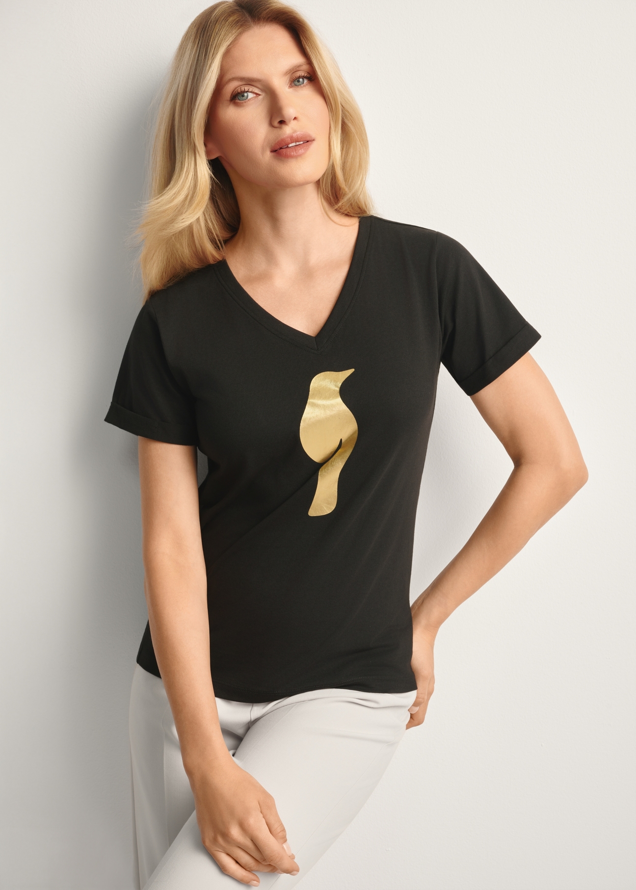 Black women's t-shirt TSHDT-0149-99(Z25), front view of the product on the model, half of the silhouette visible.