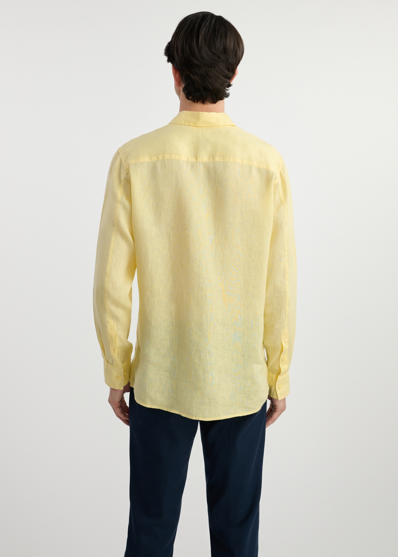 Light yellow linen men's shirt KOSMT-0321-21(W25) - back view on white background. Half of the silhouette visible.