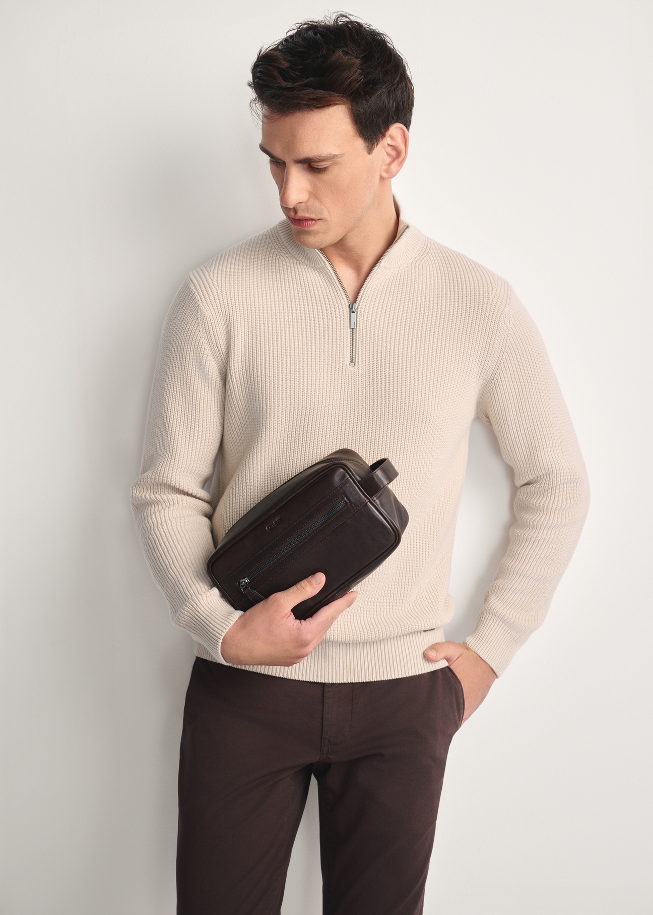 Brown men's cosmetic bag TORMS-0463-89(Z25) - front view of the product on a model against a white background. Half of the silhouette visible.