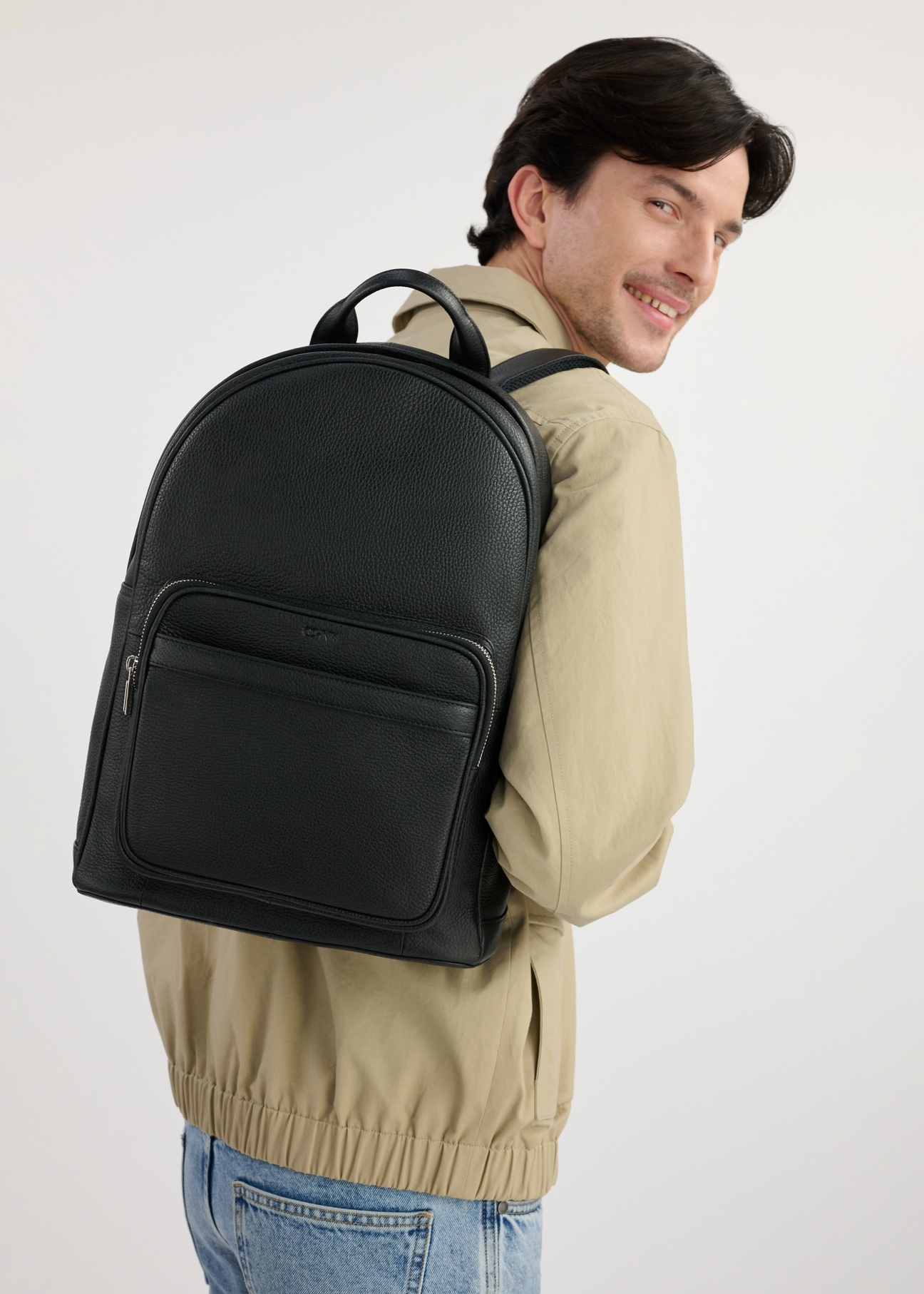 Black leather men's backpack TORMS-0450-99(W25), front product view on the model. Half of the silhouette visible.