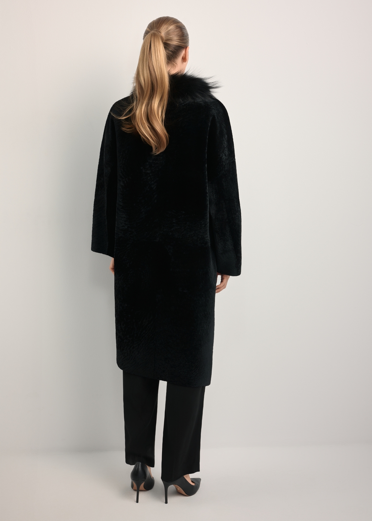Black leather double-sided women's sheepskin coat KOZDS-0093-1396(Z25), back view of the product on the model. Full body visible.