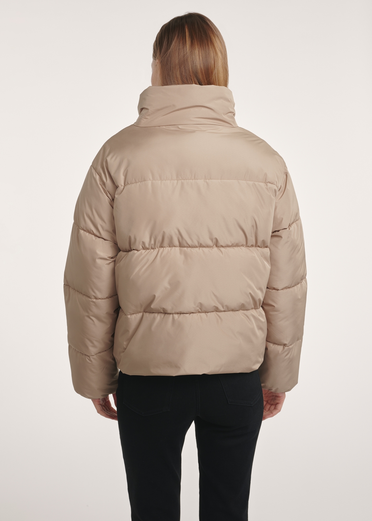 Short beige women's jacket KURDT-0601-24(Z25), product view from the back on the model. Half of the silhouette visible.