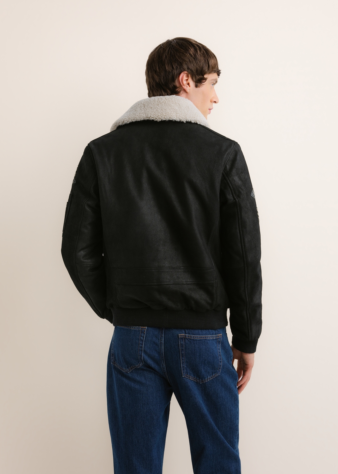 Black leather bomber jacket KURMS-0423-99(Z26), rear view on a model. Half-body shot.