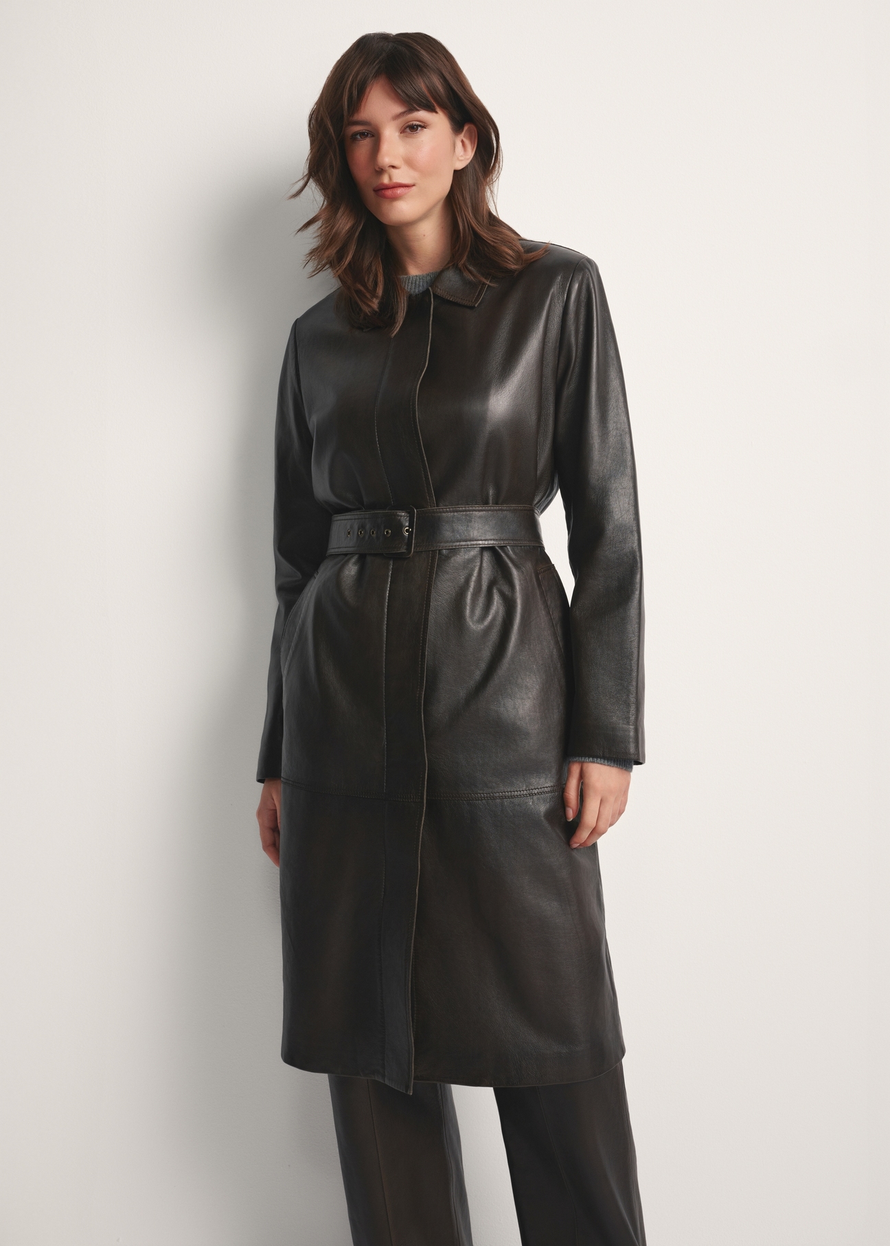 Brown women's long leather jacket KURDS-0544-2868(Z25), front view of the product on the model. Half of the silhouette visible.
