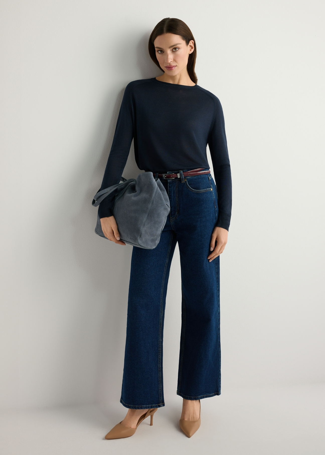 Dark blue leather women's handbag TORES-1252-7C(W26), product view in model's hand. Full body visible.