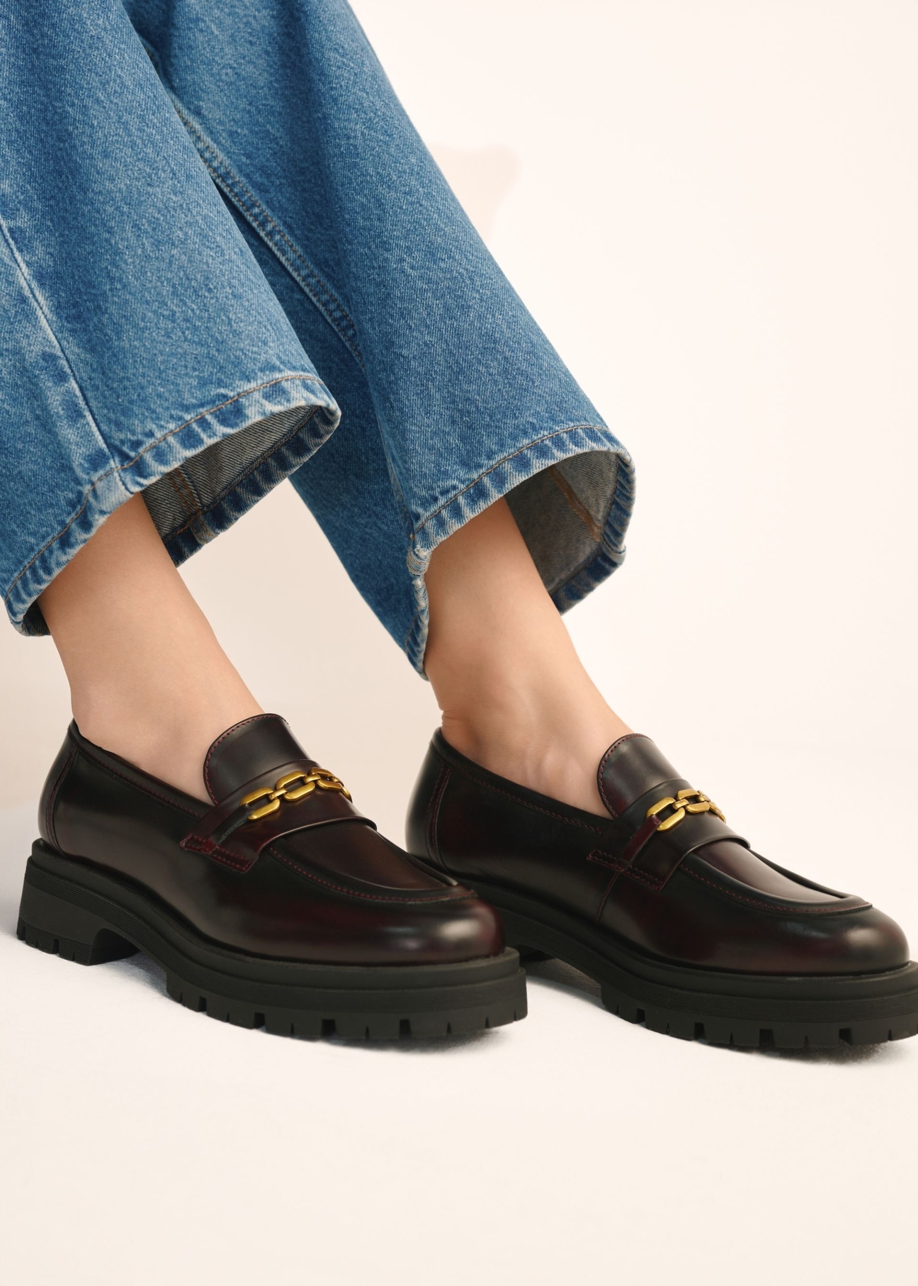 Burgundy women's leather moccasins BUTYD-1190-4E(Z26), side view of the product on the model's feet.