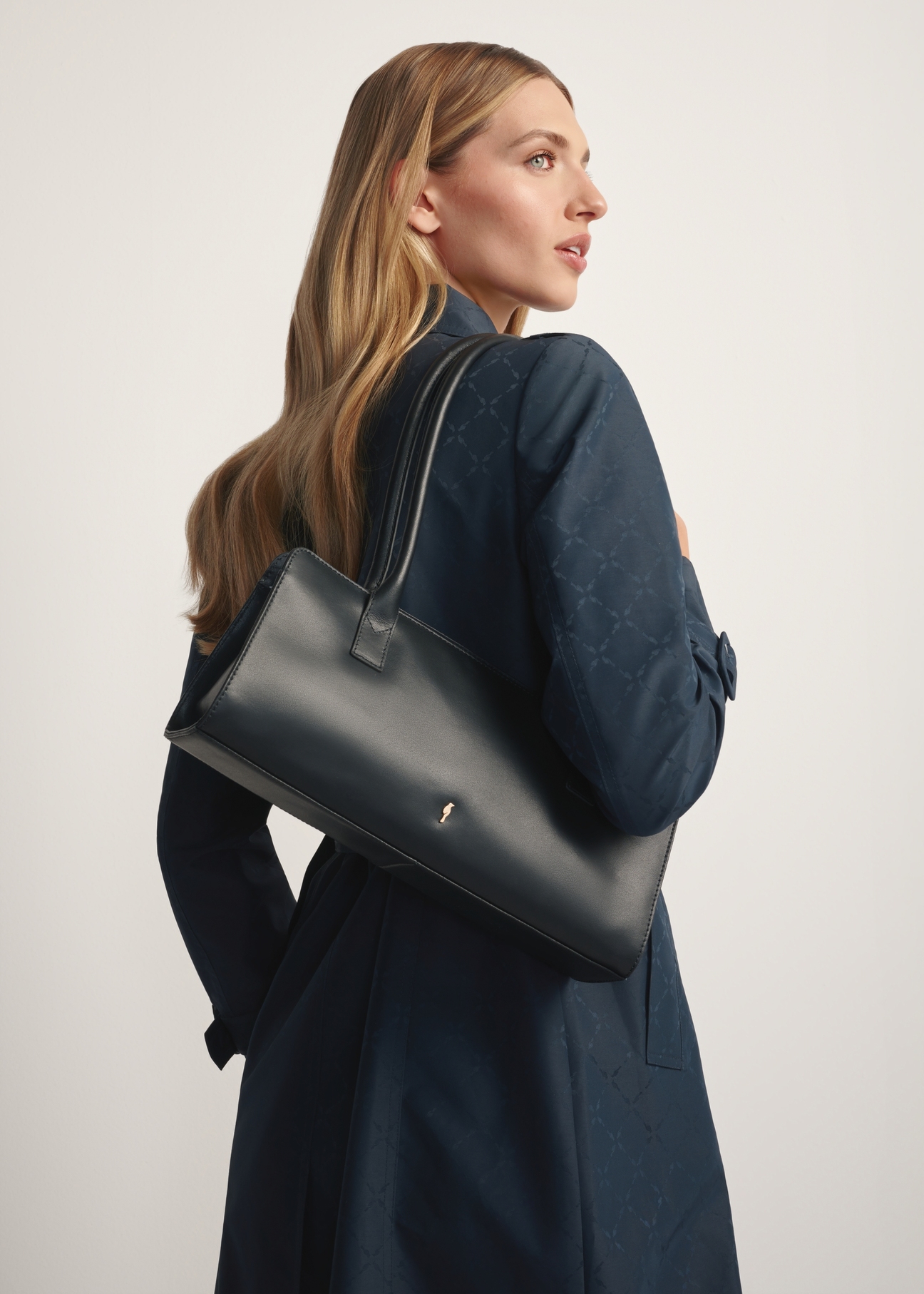 Black leather oblong women's handbag TORES-1259-99(W26) - diagonal view of the product, on a model, on a white background.