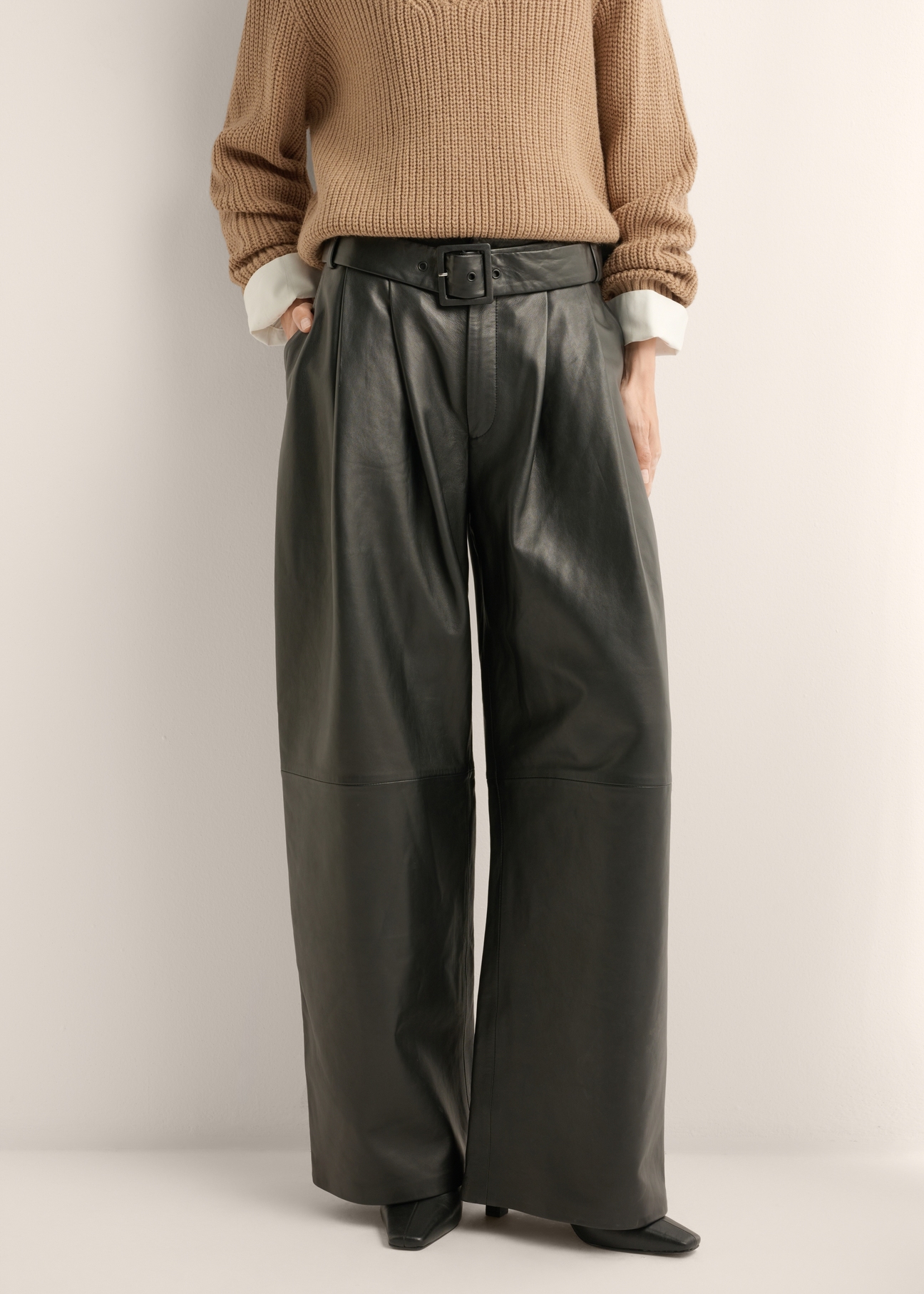 Women's wide-leg black leather trousers SPODS-0050-99(Z26), front view of the product on the model. Half of the silhouette visible.