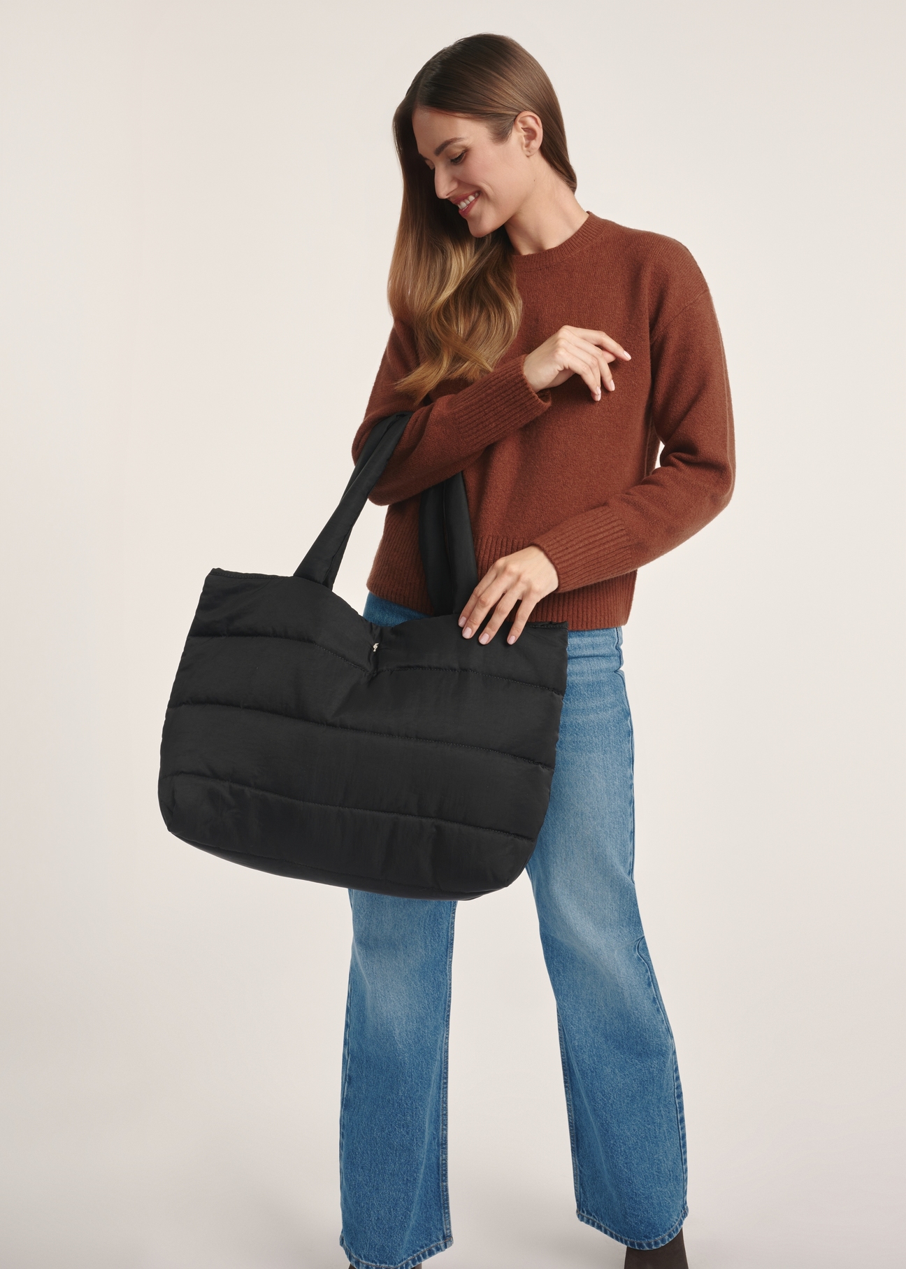 Black women's handbag TOREN-0322-99(Z25), front view of the product on a model, half of the silhouette visible.
