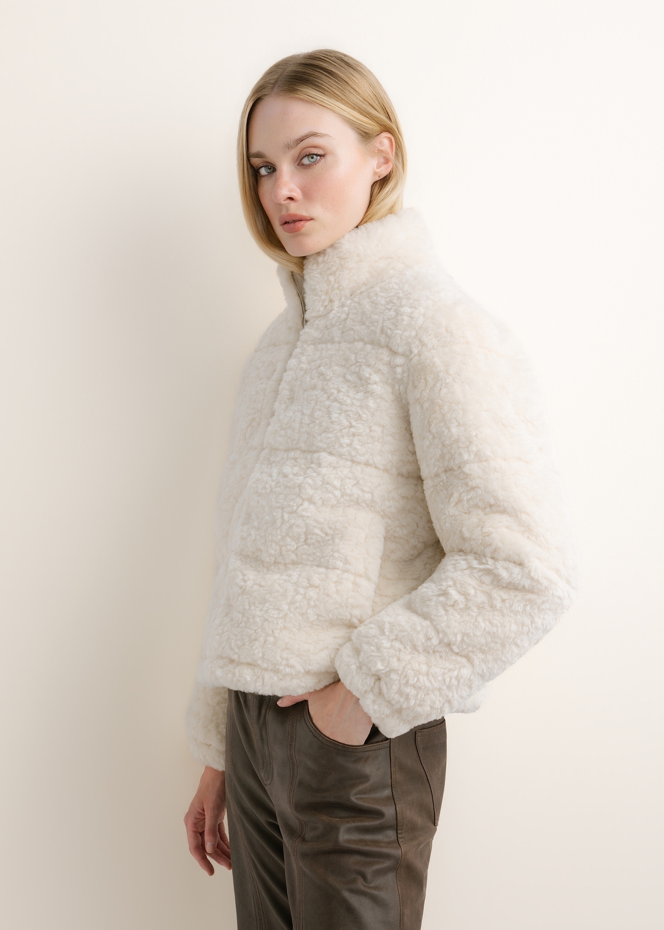 Cream-colored short women's fur coat FUTDP-0092-0B(Z26), side view on a model. Half-body shot.