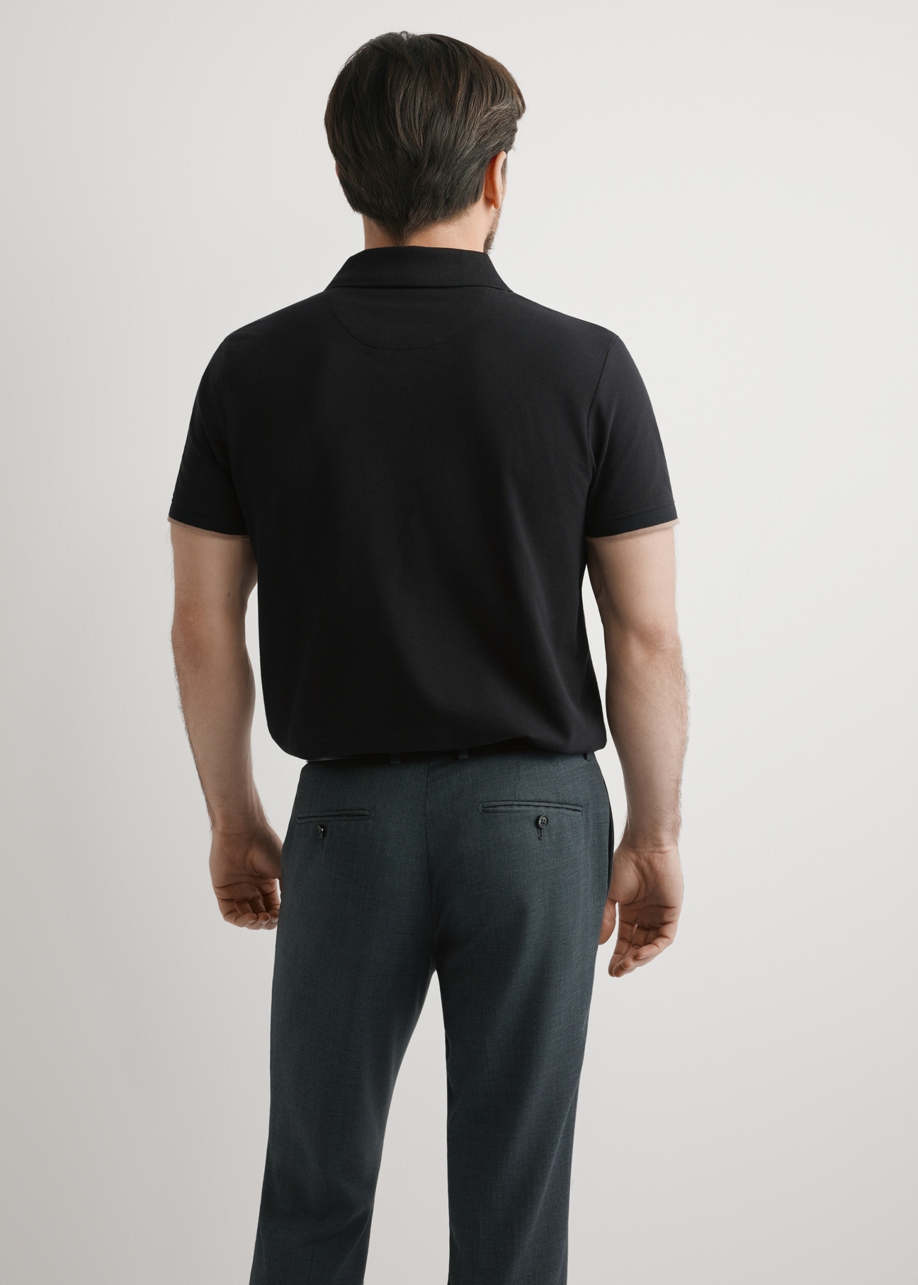 Men's black cotton polo shirt POLMT-0045B-99(W25), back view of the product on the model. Half of the silhouette visible.