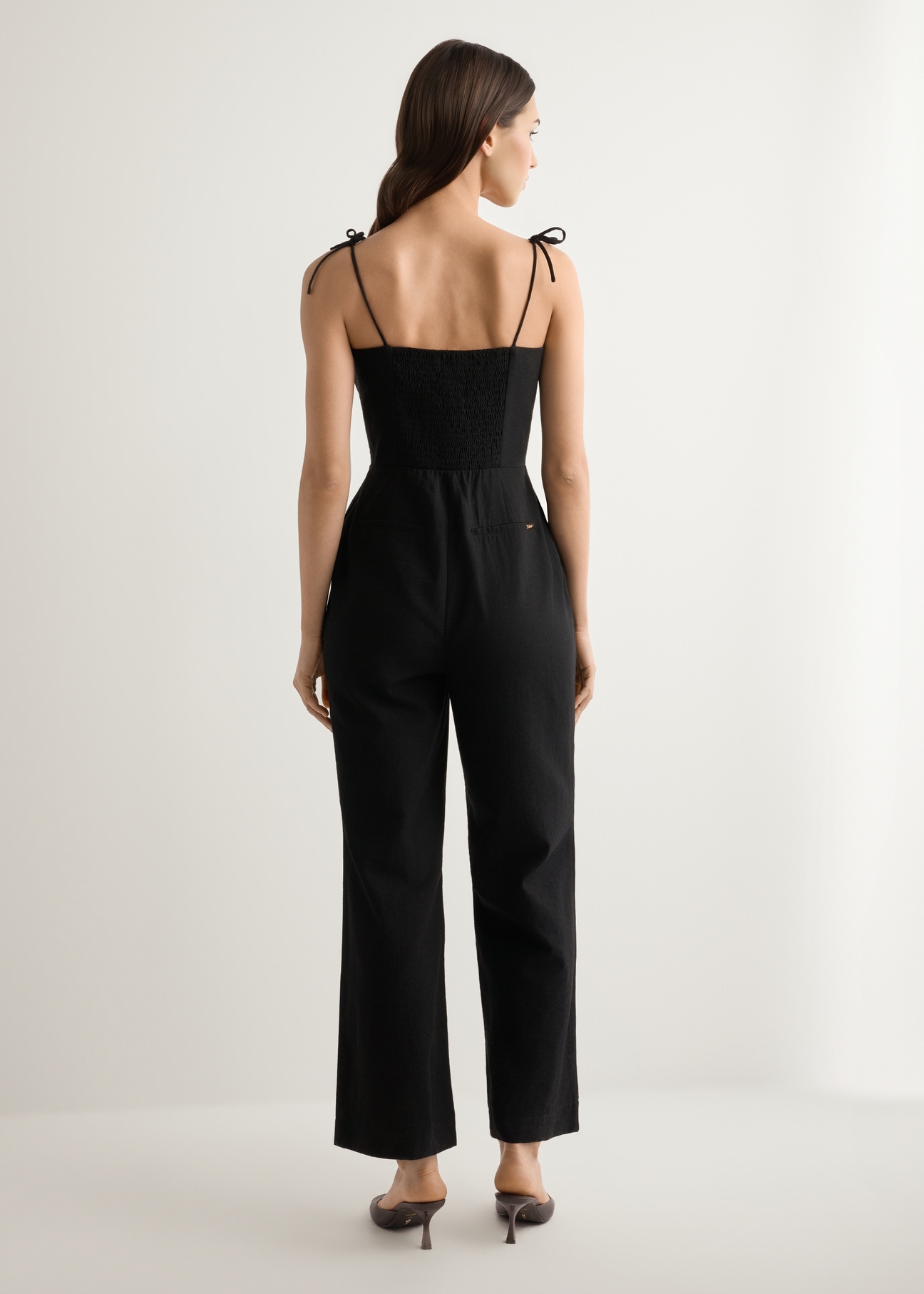 Women's black jumpsuit KOBDT-0011-99(W26), back view of the product on the model. Full body visible.