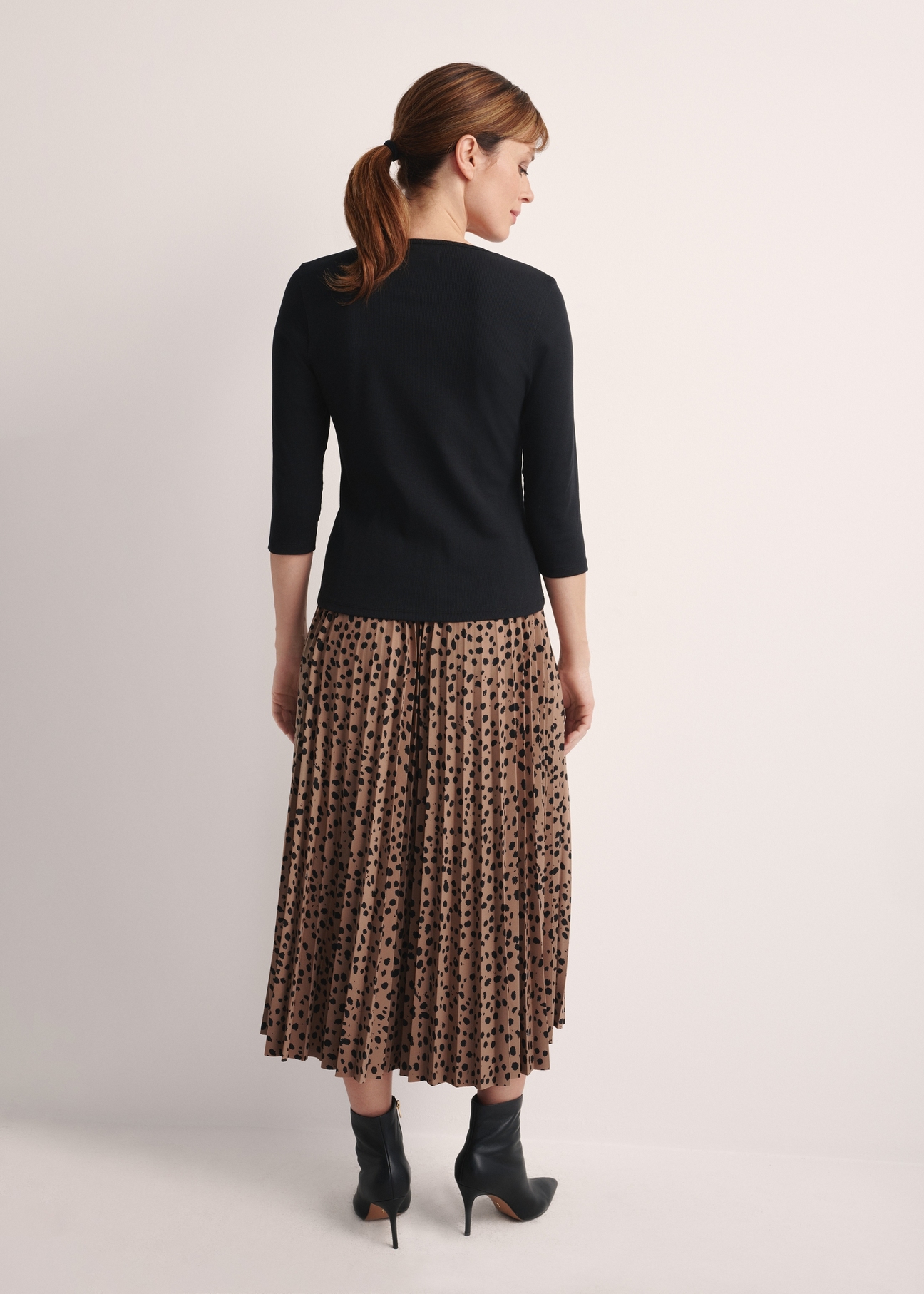 Black women's V-neck blouse LSLDT-0036-99(Z24), product view from the back on the model, the whole silhouette is visible.