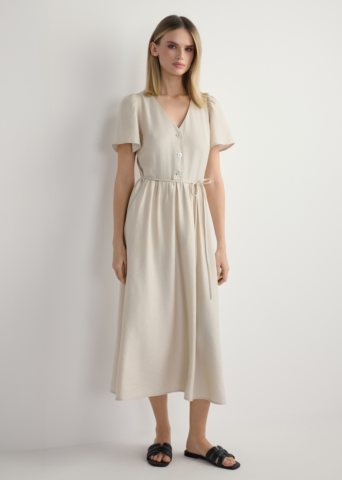 Women's light beige dress SUKDT-0255-1A(W26), front view of the product on the model. Full body visible.