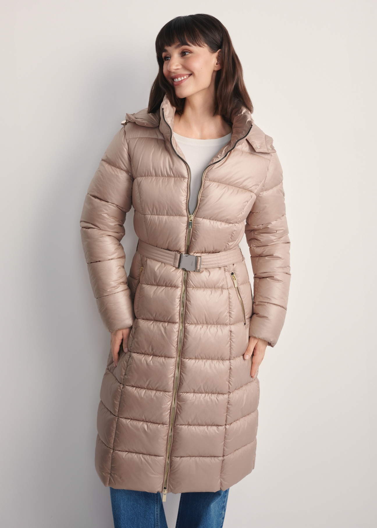 Beige women's long jacket KURDT-0603-82(Z25), front view of the product on the model. Half of the silhouette visible.