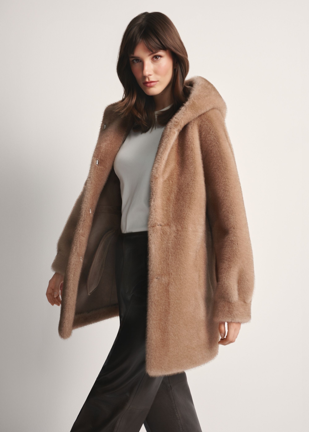 Women's beige fur coat with hood FUTDP-0062-1B(Z26) , front view of the product on the model. Half of the silhouette visible.