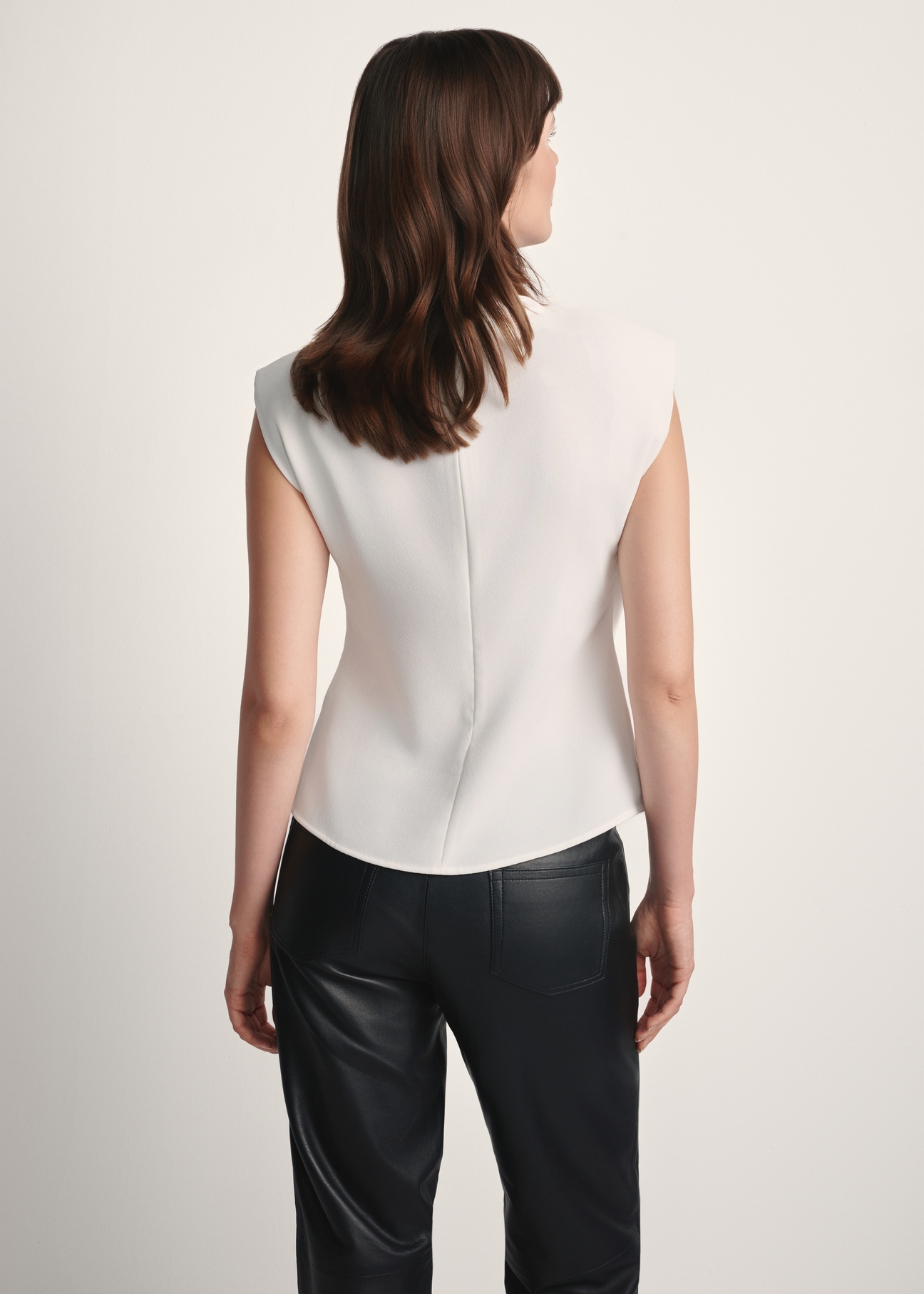 White elegant women's blouse BLUDT-0195-12(Z25), product view from the back on the model, half of the silhouette visible.