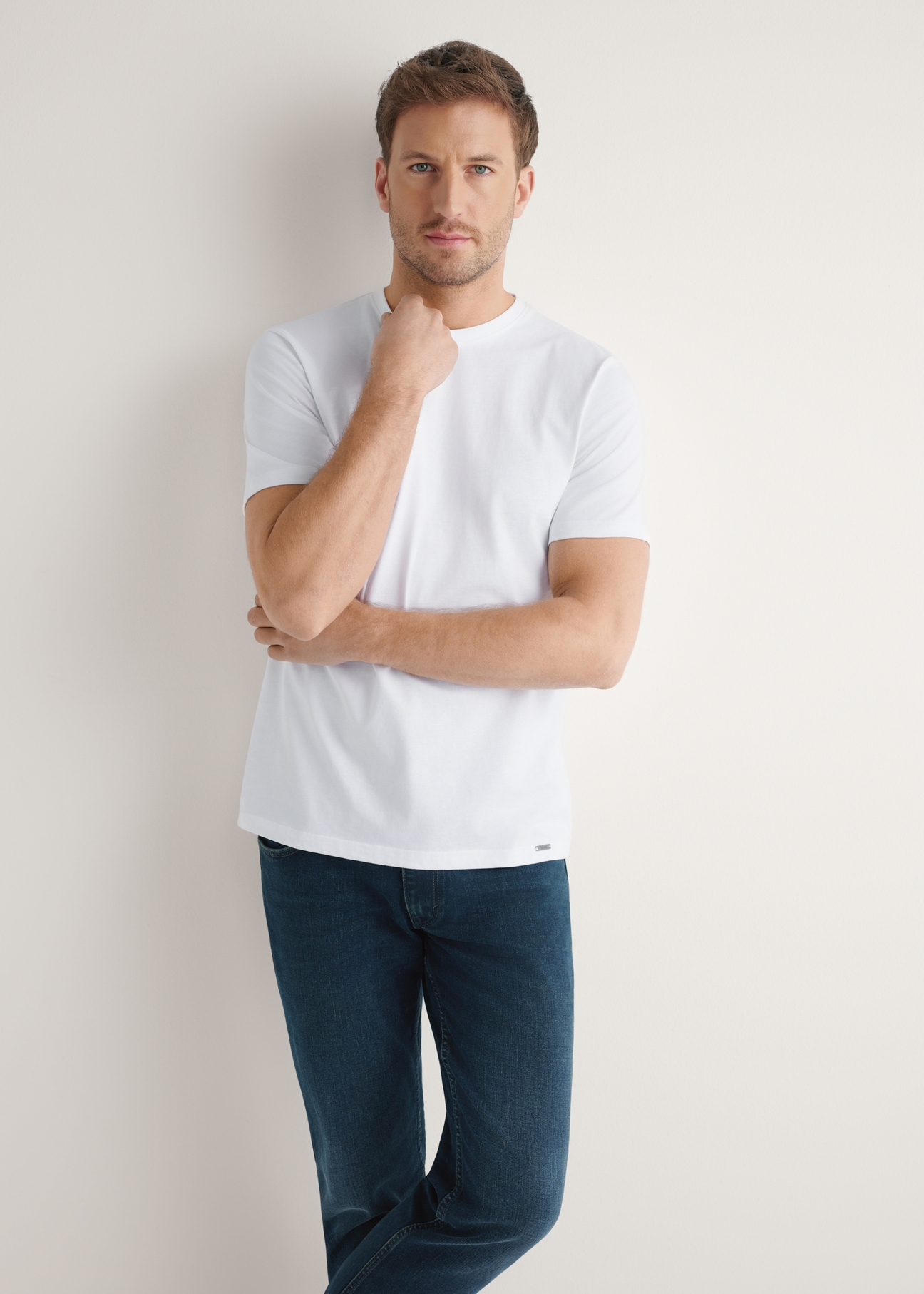Men's white cotton t-shirt TSHMT-0144-0A(W26) - front view of the product, on a model, against a light background. Half-length silhouette visible.