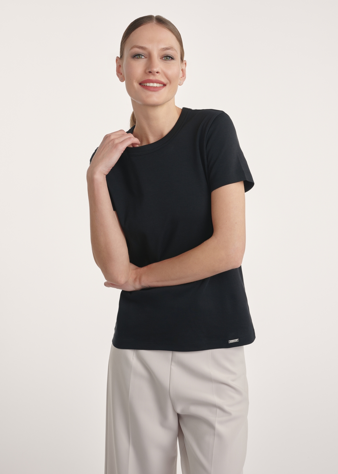 Black cotton women's t-shirt TSHDT-0144-99(Z25) - front view on a model on a white background. Half of the silhouette visible.