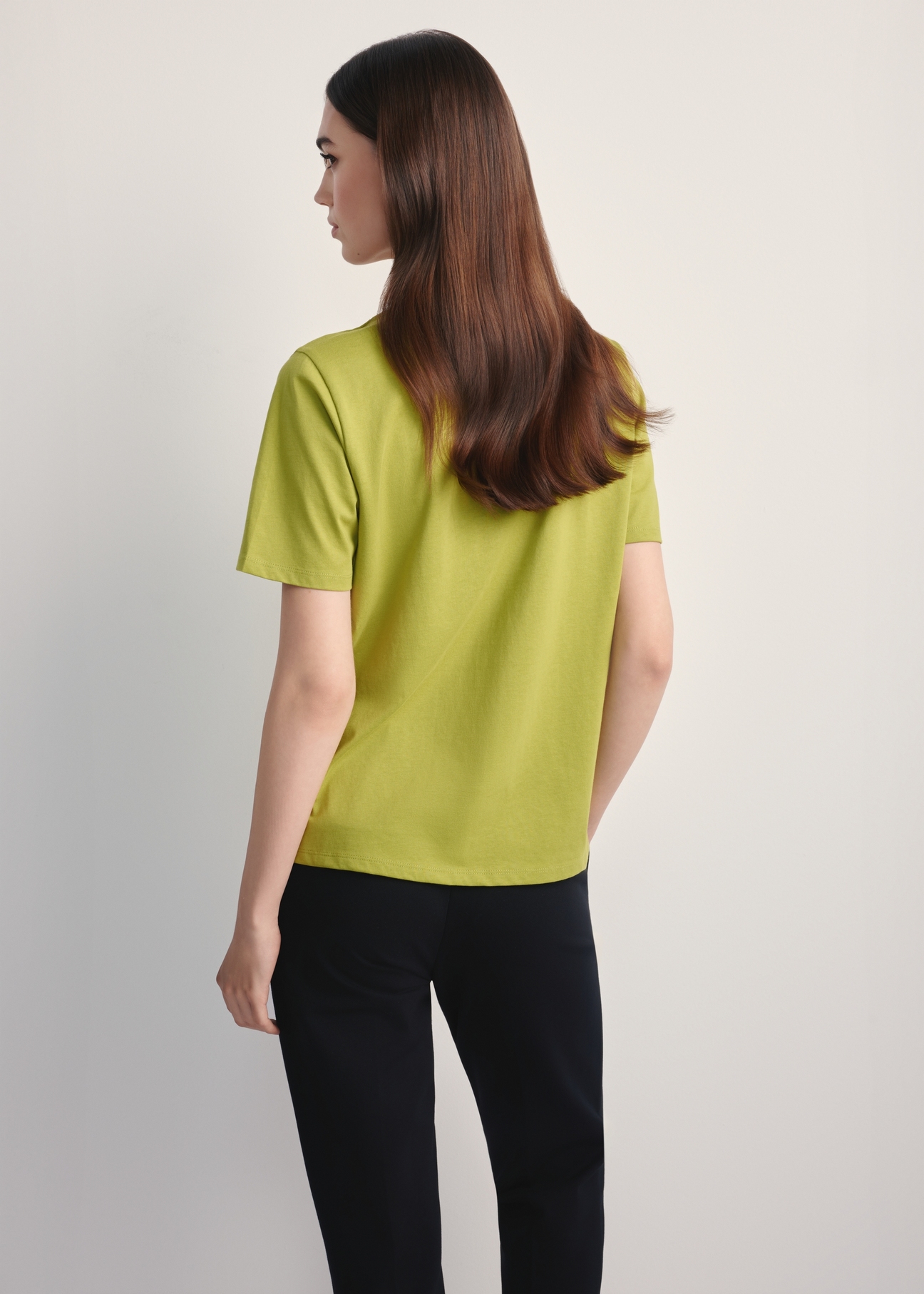 Women's lime green T-shirt TSHDT-0143-84(Z25), back view of the product on the model. Half of the silhouette visible.