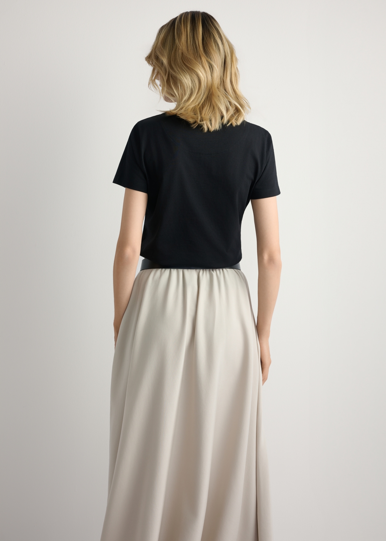 Black women's T-shirt with logo TSHDT-0157-99(W26), back view of the product on the model. Half of the silhouette visible.