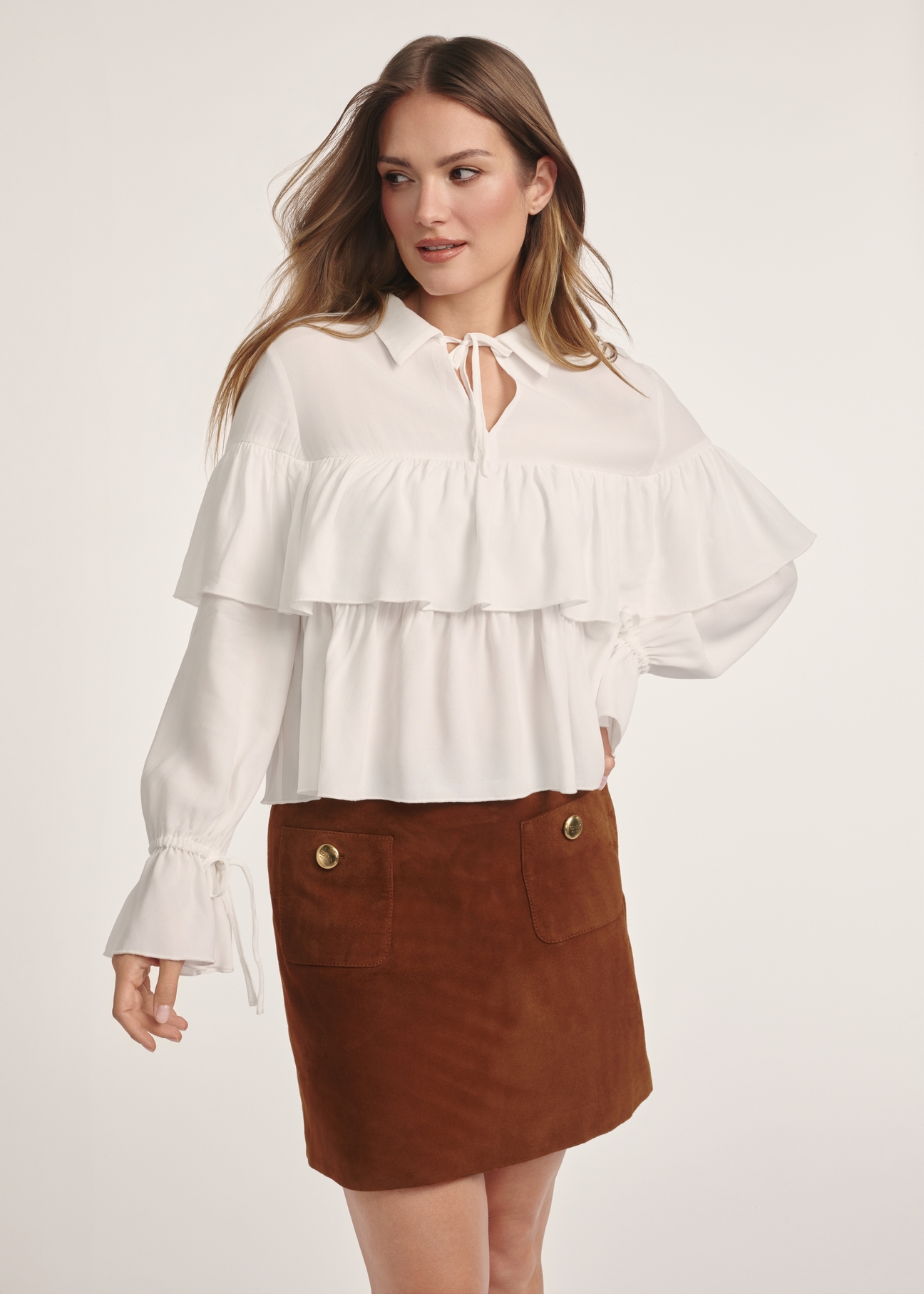 Women's white blouse with frills BLUDT-0198-12(Z25), front view of the product on the model. Half of the silhouette visible.