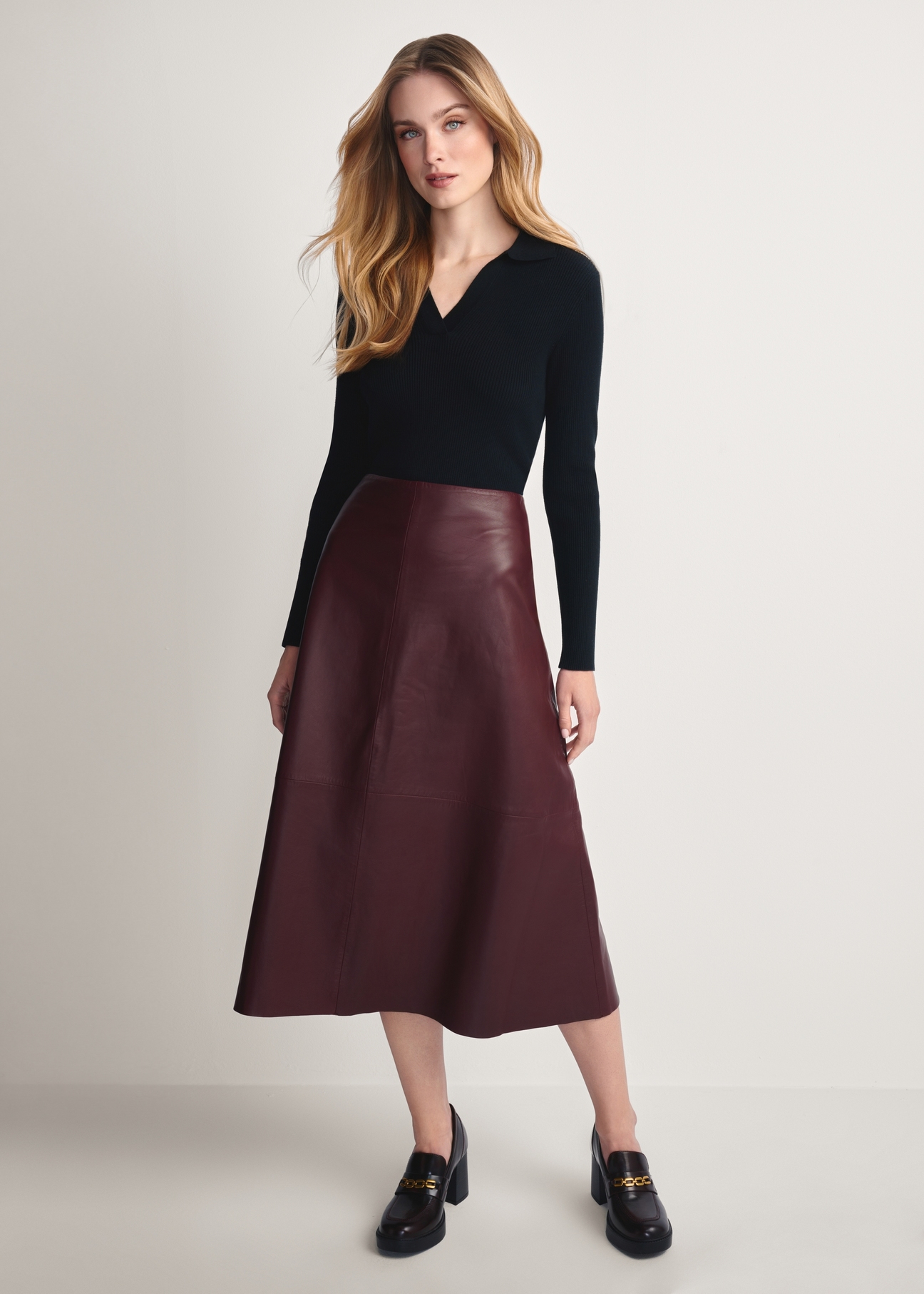 Burgundy leather midi skirt SPCDS-0077-2869(Z25), front product view on model. Full silhouette visible.